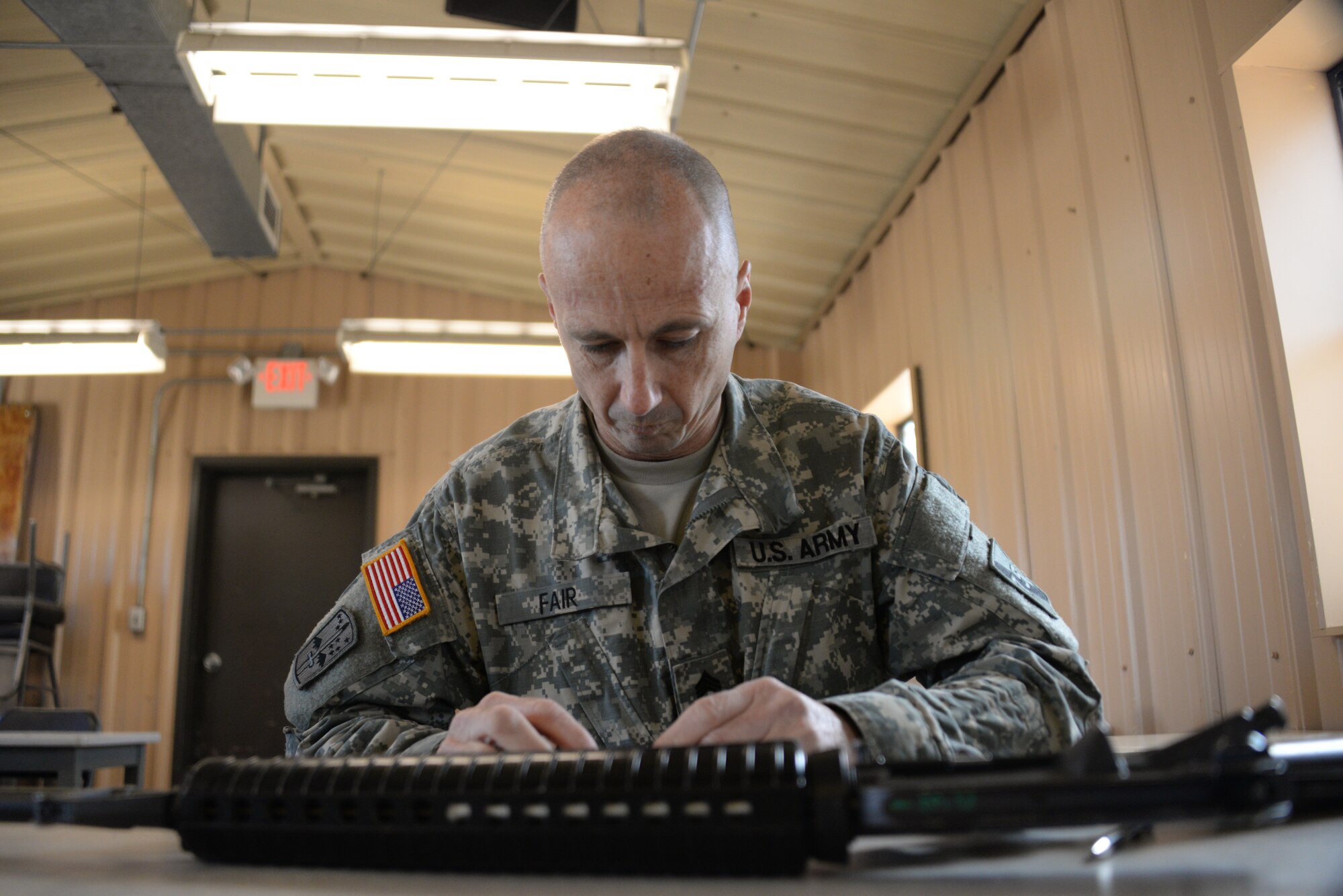 Army Staff Sgt. Daniel Fair, a member of the 75th Training Command Southern Division, breaks down his weapon during the Best Warrior Competition on Joint Base McGuire-Dix-Lakehurst, N.J., April 11, 2015. Winners of the competition are named Soldier and NCO of the year. (U.S. Air Force photo/Airman 1st Class Lauren Pitts) 
