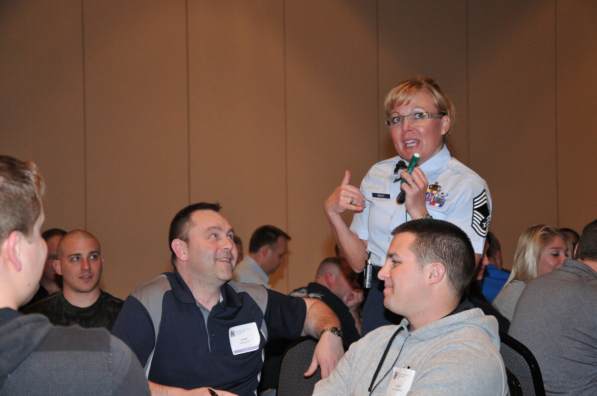 Chief Master Sgt. Jennifer Reecy, South Dakota Air National Guard Headquarters personnel superintendent, talks with unit members and their spouses during the Yellow Ribbon Reintegration Program event at the Sioux Falls Convention Center April 11.  The event came prior to deployment of Airmen from the South Dakota Air National Guard and was designed to prepare Airmen and their families for needs that can arise during a deployment. (National Guard photo by Tech. Sgt. Christopher Stewart/Released)