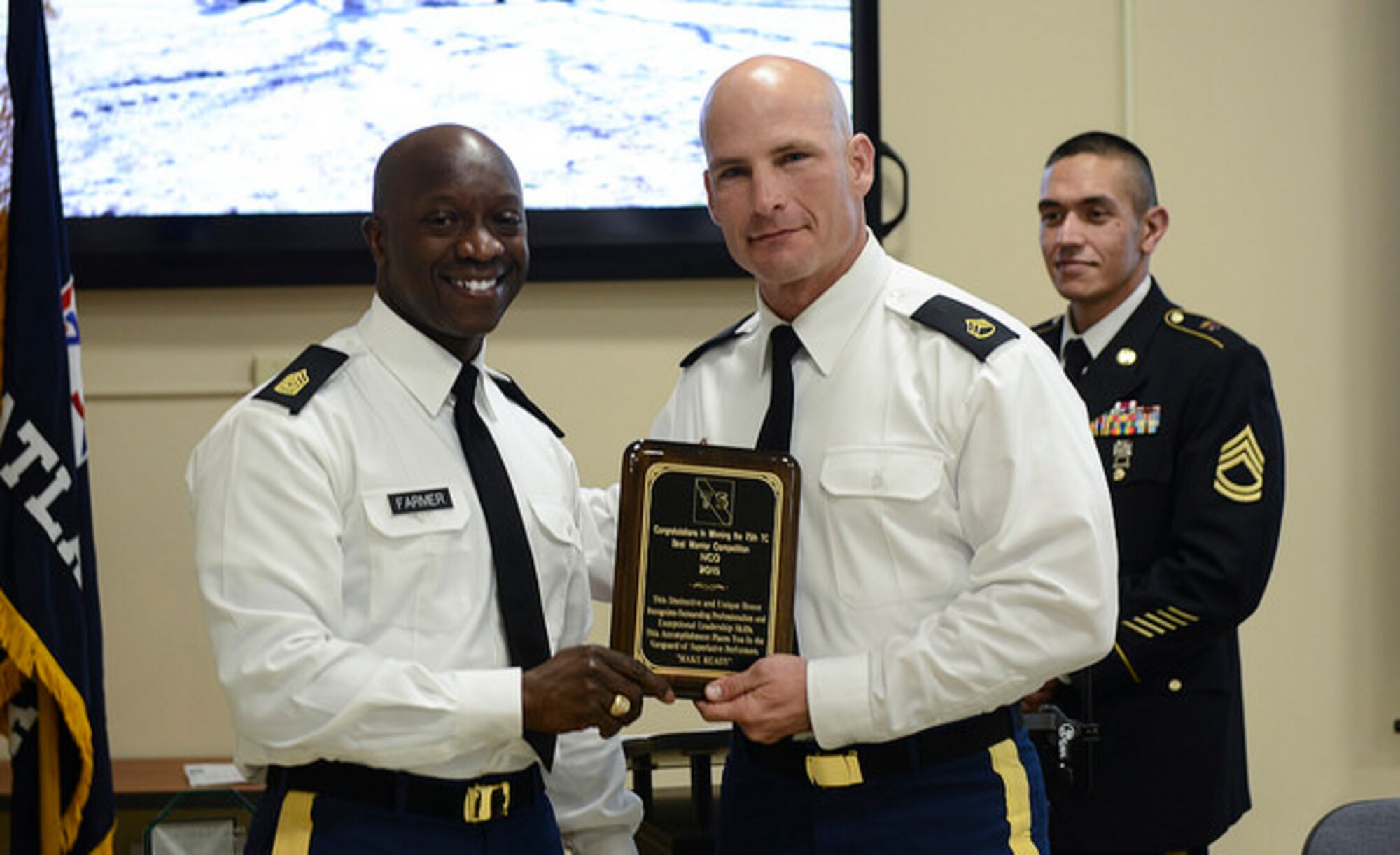 75th Training Command Command Sgt. Maj. Ronnie Farmer awards Army Staff Sgt. Orval Emery, a resident of Colorado and a member of the 75th Training Command Pacific Division, the Best Warrior Competition NCO of the year plaque, on Joint Base McGuire-Dix-Lakehurst, N.J. April 12, 2015. Emery will advance to represent the 75th TC at the U.S. Army Reserve Best Warrior Competition at Fort Bragg, N.C. in May. (U.S. Air Force photo by Airman 1st Class Joshua King)
