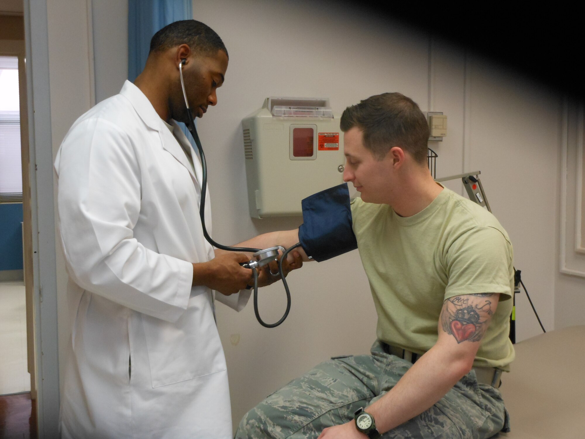 Dr. Derric Whiteside, 779th Medical Operations Squadron, Internist, takes the blood pressure of Senior Airman Timothy McSheehy, 779th Medical Operations Squadron, Medical Technician.