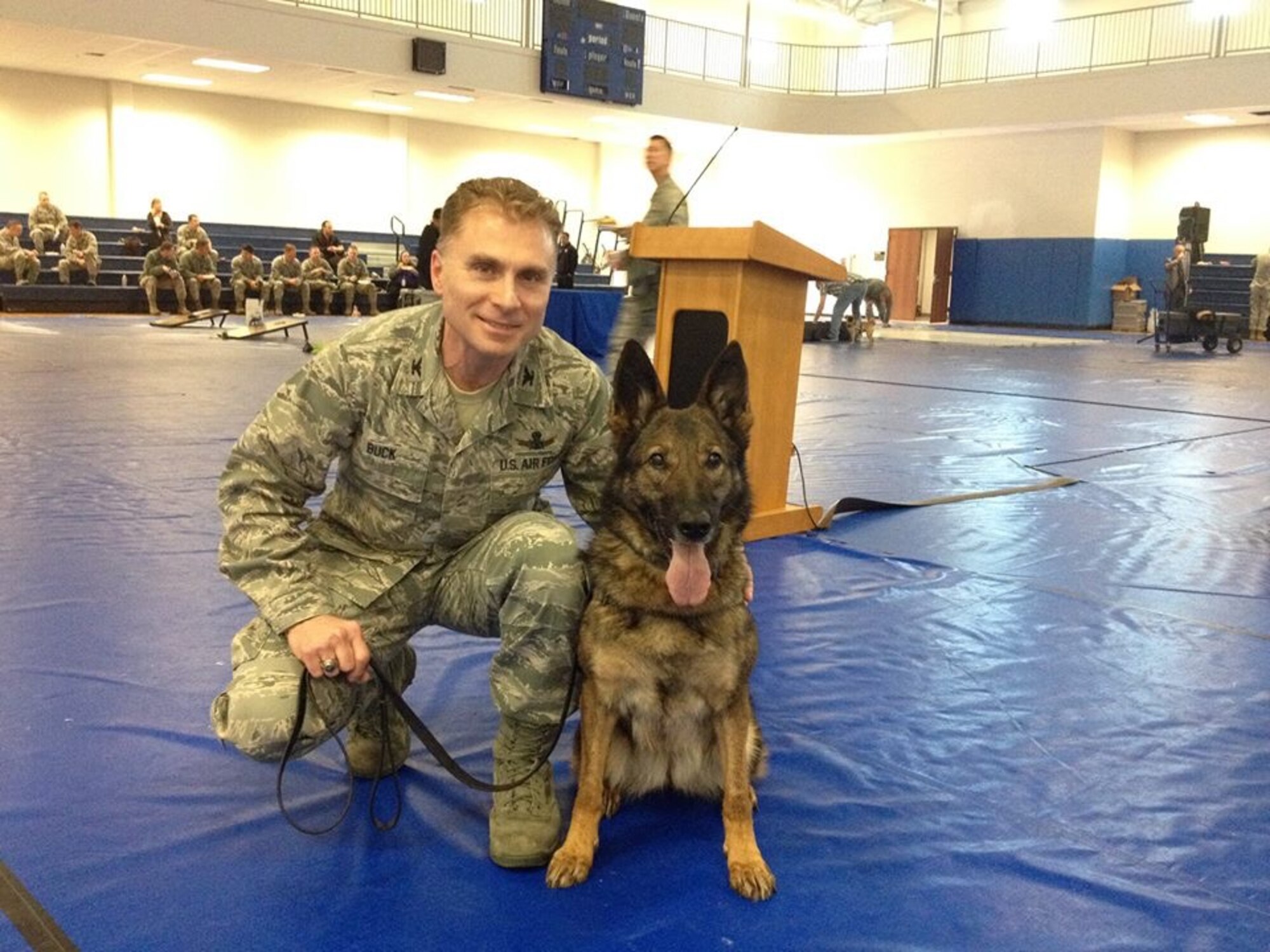 Col. Darren Buck, 460th Space Wing vice commander poses with military working dog, Nina. (courtesy photo)