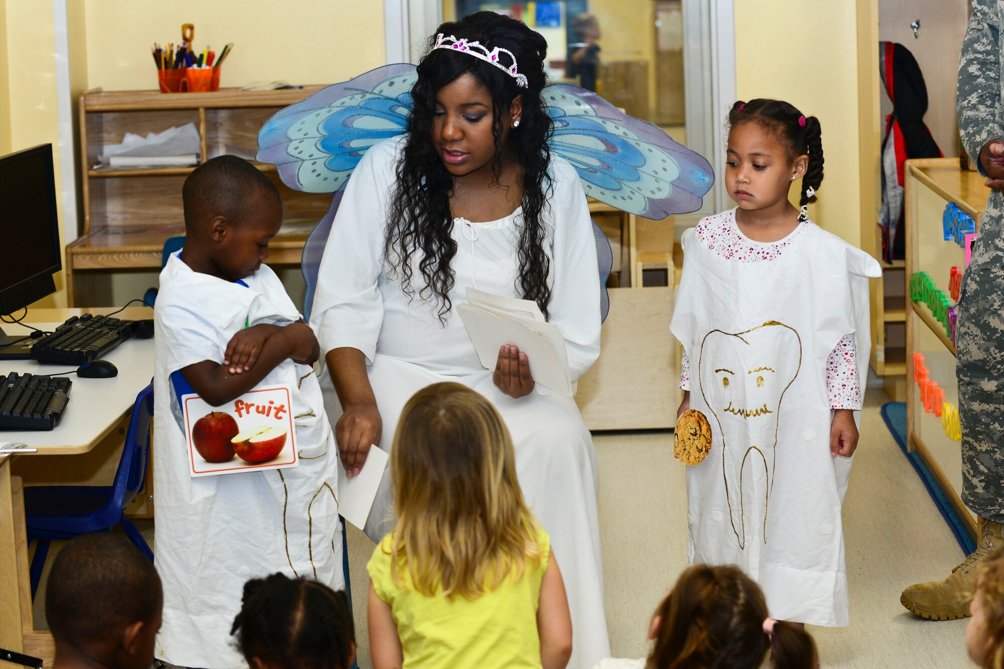 U.S. Army Spc. Alicia Elam, Fort Eustis Dental Command dental specialist, uses “happy teeth” and “sad teeth” to demonstrate healthy food choices at the Pershing Child Development Center in honor of Month of the Military Child at Fort Eustis, Va., April 14, 2015. During her visit to the CDC, Elam spoke to classes about healthy dental habits. (U.S. Air Force photo by Senior Airman Kimberly Nagle/Released)