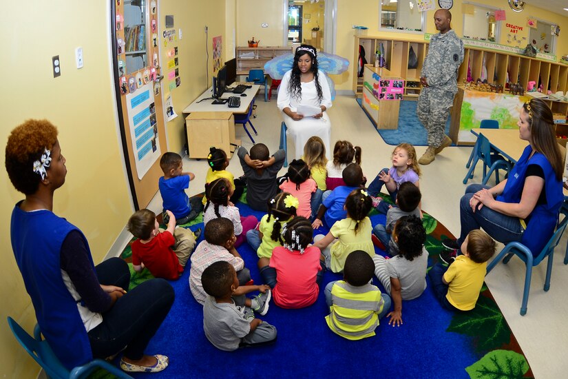Members from the Fort Eustis Dental Command visit the Pershing Child Development Center, for Month of the Military Child at Fort Eustis, Va., April 14, 2015. The “Tooth Fairy,” played by U.S. Army Spc. Alicia Elam, Fort Eustis Dental Command dental specialist, discussed how eating habits can affect dental health while visiting with the children. (U.S. Air Force photo by Senior Airman Kimberly Nagle/Released)