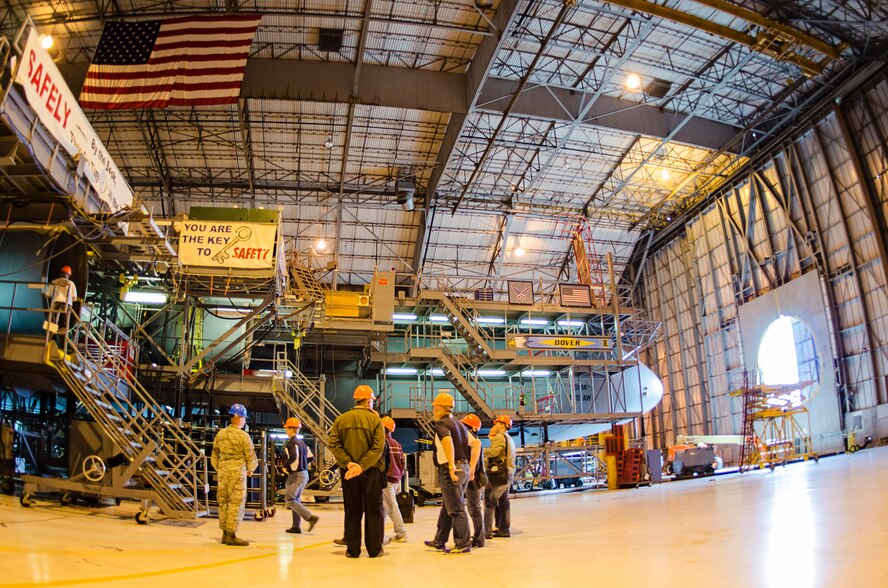 Team Dover's Honorary Commanders tour the C-5M Super Galaxy isochronal maintenance dock, here, as part of their Maintenance Group tour around the base, April 15. Team Dover's honorary commander program, which began in 1992, matches leaders from across the state of Delaware with base commanders from the 436th Airlift Wing, 512th Airlift Wing, Air Force Mortuary Affairs Operations Center, Armed Forces Medical Examiner System, Joint Personal Effects Depot, and the 373rd Training Squadron, Detachment 3 to help them better understand Dover's mission.