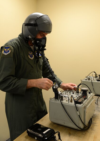Maj. Gen. Scott Vander Hamm, 8th Air Force commander, uses an oxygen mask test unit to make sure his helmet works properly on Barksdale Air Force Base, La., April 13, 2015. The machine is used to test aircrew equipment for leaks and simulates an altitude of up to 48,000 feet. (U.S. Air Force photo/Senior Airman Joseph A. Pagan Jr.)