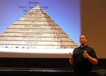 Josh Jasper, Mentors in Violence Prevention Program facilitator, briefs military and civilians on sexual assault prevention April 10 at Joint Base San Antonio-Randolph’s Fleenor Auditorium. During the event, Jasper led a discussion through a multimedia presentation called the ‘Power of the Pyramid’ using dozens of media and pop culture examples to illustrate how seemingly harmless behavior can progress to violence. The presentation was part of a series of Sexual Assault Awareness Prevention Month events being held throughout April across JBSA.  (U.S. Air Force photo by Harold China)

