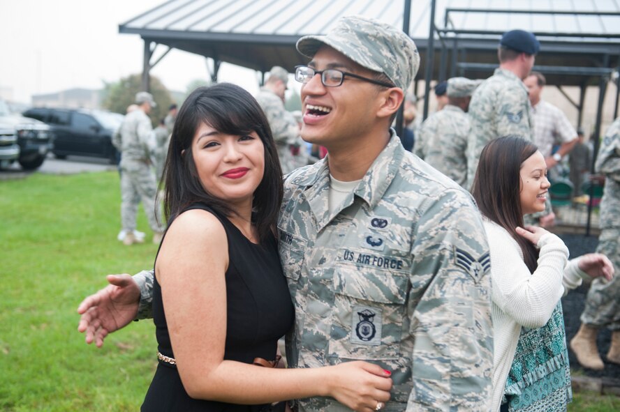 U.S. Air Force Senior Airman Josel Smith, 823d Base Defense Squadron fire team member, shares a laugh with his wife at a deployment ceremony April 14, 2015, at Moody Air Force Base, Ga. Josel and Airmen from his squadron left for a deployment to Southwest Asia following the ceremony. (U.S. Air Force photo by Airman 1st Class Dillian Bamman/Released)