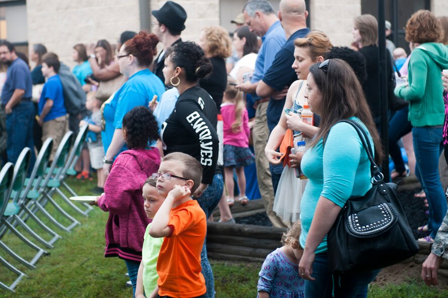 Friends and family of 823d Base Defense Squadron service members listen during a deployment ceremony April 14, 2015, at Moody Air Force Base, Ga. More than 100 Airmen from the 823d Base Defense Squadron deployed to Southwest Asia. (U.S. Air Force photo by Airman 1st Class Dillian Bamman/Released)