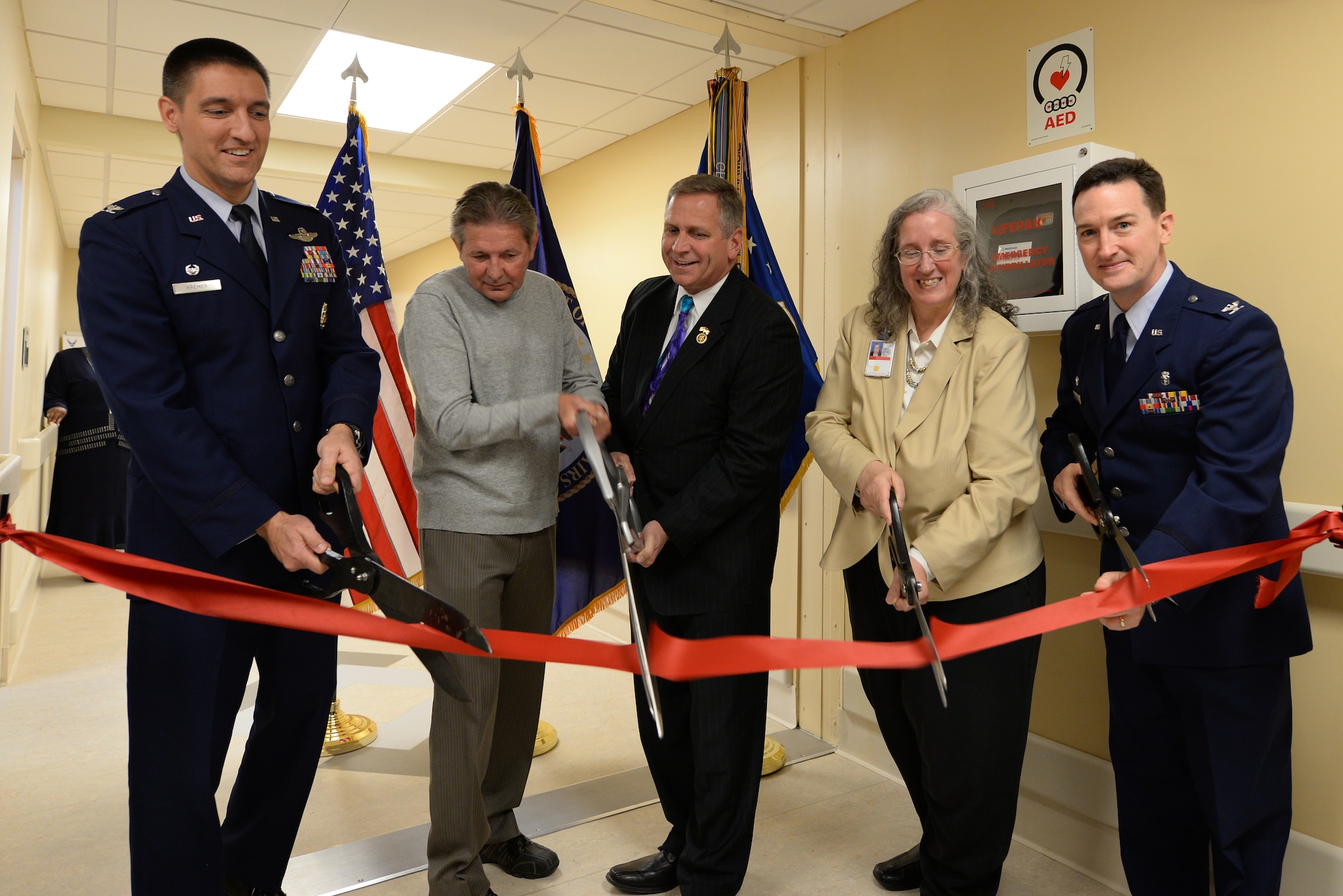 Col. Kyle Kremer, Gary Triplett, Mike Bost, Denise Deitzen, and Col. Bret Burton, cut a ribbon signifying the opening of the Veterans Affairs Compensation and Pension Clinic April 10 at Scott Air Force Base, Illinois. Kremer is the 375th Air Mobility Wing commander, Triplett is a veteran, Bost is a U.S. Congressman for Illinois, Dietzen is the interim director for VA St. Louis Health Care System, and Burton is the 375th Medical Group commander. (U.S. Air Force photo/ Senior Airman Sarah Hall-Kirchner)