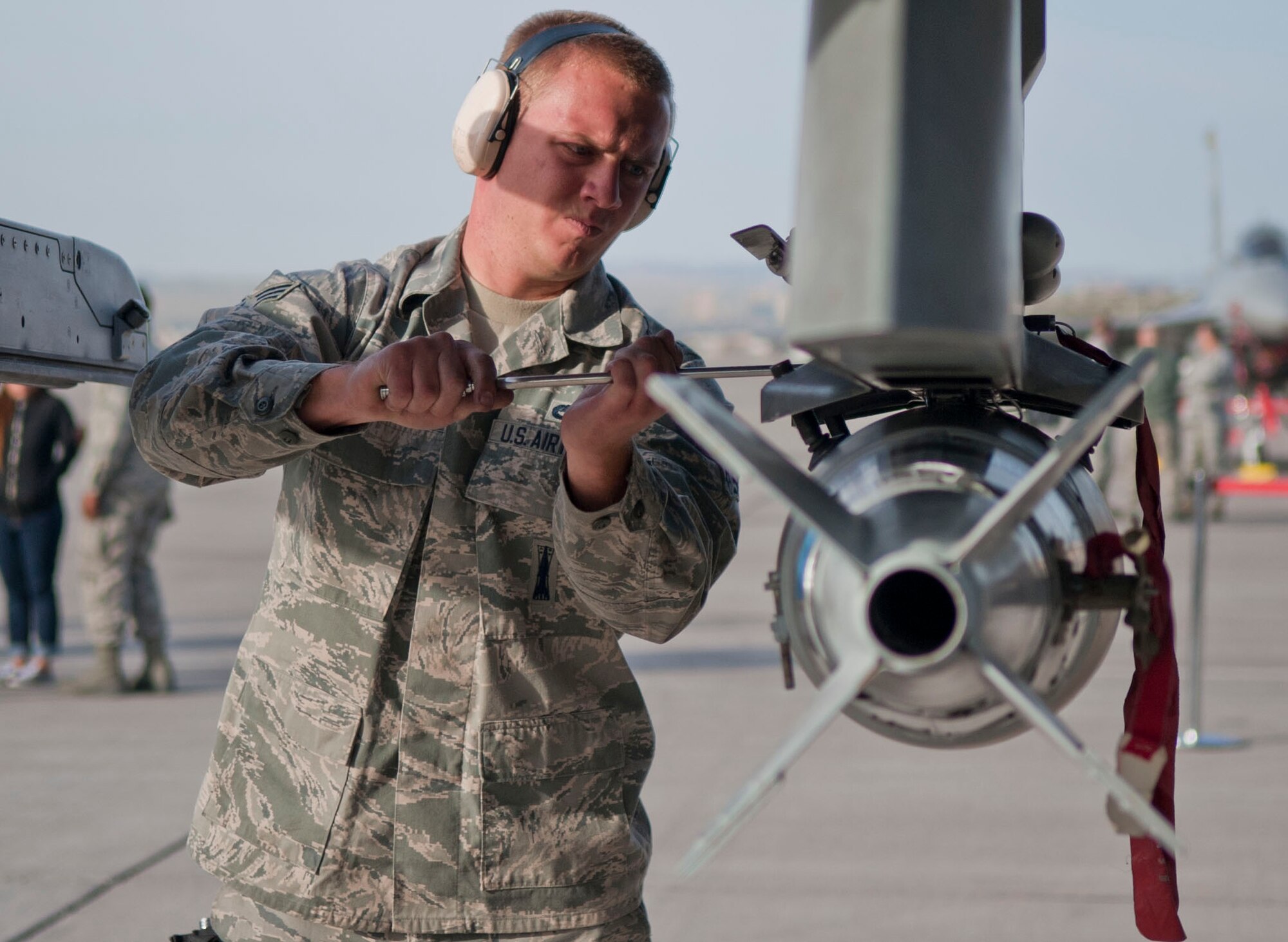 Senior Airman Bradley Meyer, Viper Aircraft Maintenance Unit weapons load crew member, tightens a munition onto an F-16 Fighting Falcon’s weapons station during a quarterly weapons load crew competition at Nellis Air Force Base, Nev., April 10, 2015. Load crew competitions occur quarterly and provide crews the chance to compete in the annual weapons load crew competition. (U.S. Air Force photo by Airman 1st Class Mikaley Towle)
