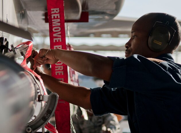 Staff Sgt. David Bridges, Eagle Aircraft Maintenance Unit weapons load crew chief, tightens a part on a munition during a quarterly weapons load crew competition at Nellis Air Force Base, Nev., April 10, 2015. Weapons load teams are evaluated on their ability to properly follow all checklists, technical orders and safety procedures. (U.S. Air Force photo by Airman 1st Class Mikaley Towle)