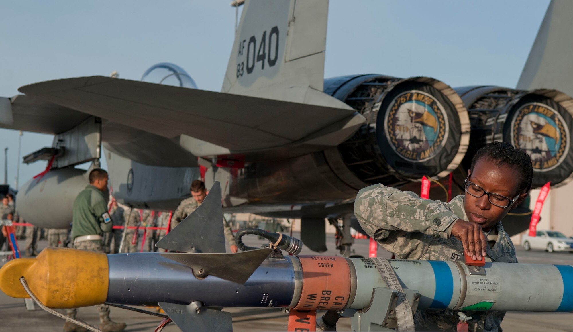Senior Airman Jasmine Stitt, Eagle Aircraft Maintenance Unit weapons load crew member, prepares a munition to be loaded onto an F-15 Eagle aircraft during a quarterly weapons load crew competition at Nellis Air Force Base, Nev., April 10, 2015. During the competition, load crew members are evaluated on a written test, dress and appearance inspection, composite tool kit inspection, and the weapons load. (U.S. Air Force photo by Airman 1st Class Mikaley Towle)
