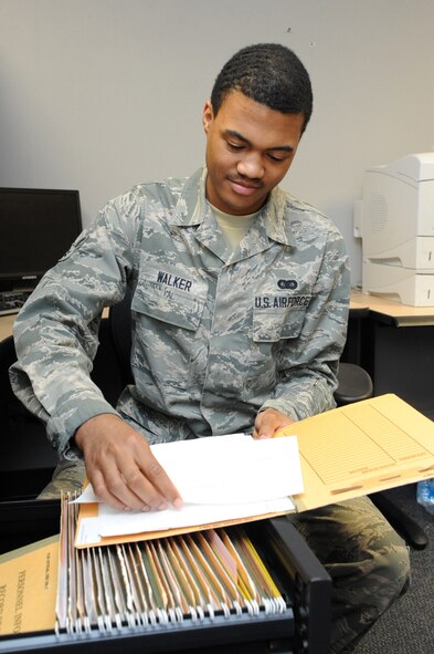 Airman 1st Class Jamal Walker, 319th Comptroller Squadron commander support staff member, reviews feedback notifications on Grand Forks Air Force Base, N.D., April 14, 2015. Walker was selected at the base's Warrior of the Week for the third week of April 2015. (U.S. Air Force photo by Staff Sgt. David Dobrydney/Released)