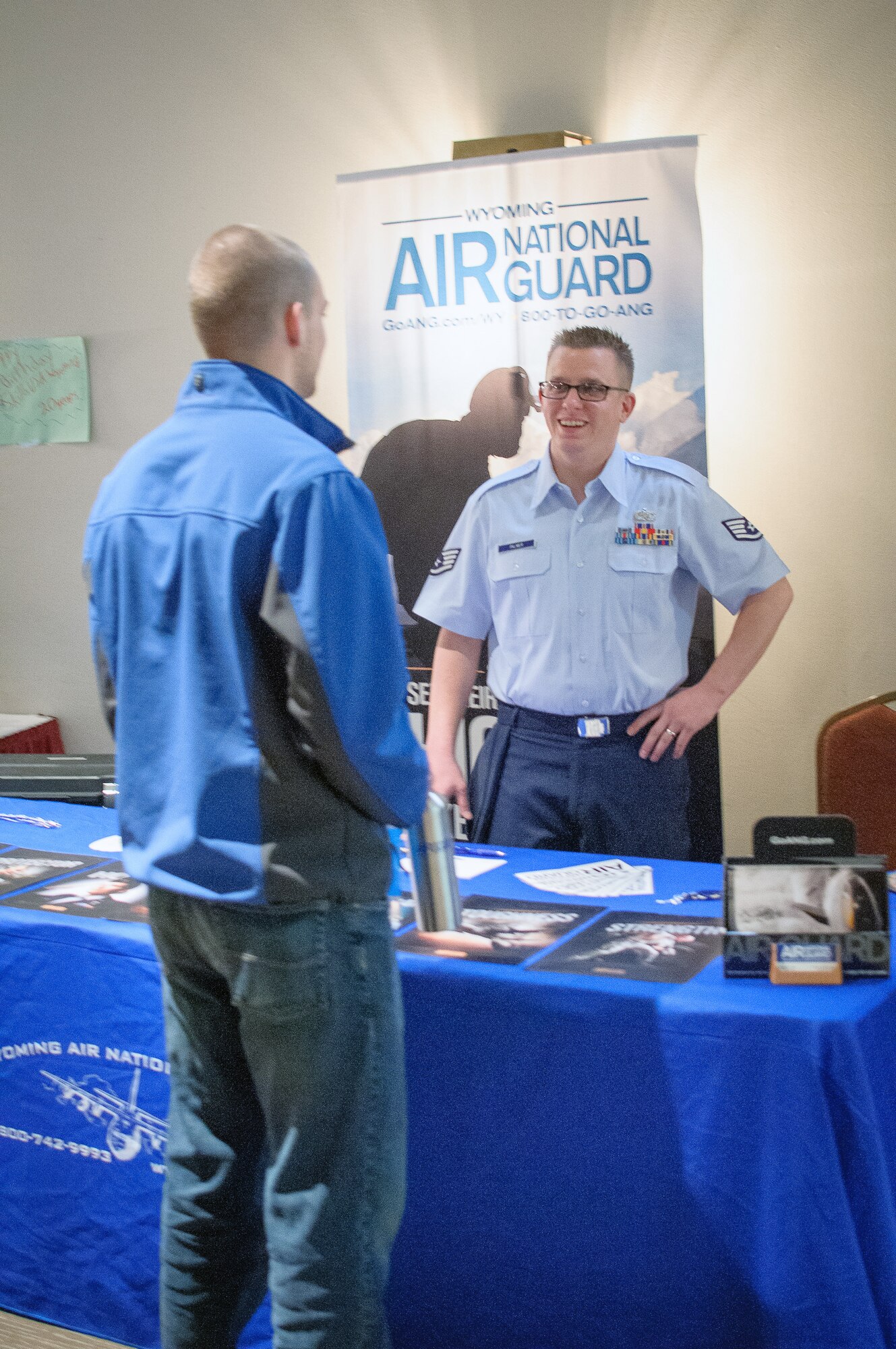 U.S. Air Force Staff Sgt. Michael Palmer, Wyoming Air National Guard recruiter discusses enlistment opportunities with potential enlistees during the SkillsUSA competition, Apr. 13, 2015 in Casper, Wyoming. SkillsUSA Wyoming is a career-technical student organization serving students in secondary and post-secondary technical, skilled, service, and health occupations. (U.S. Air National Guard photo by Tech. Sgt. John Galvin/released)