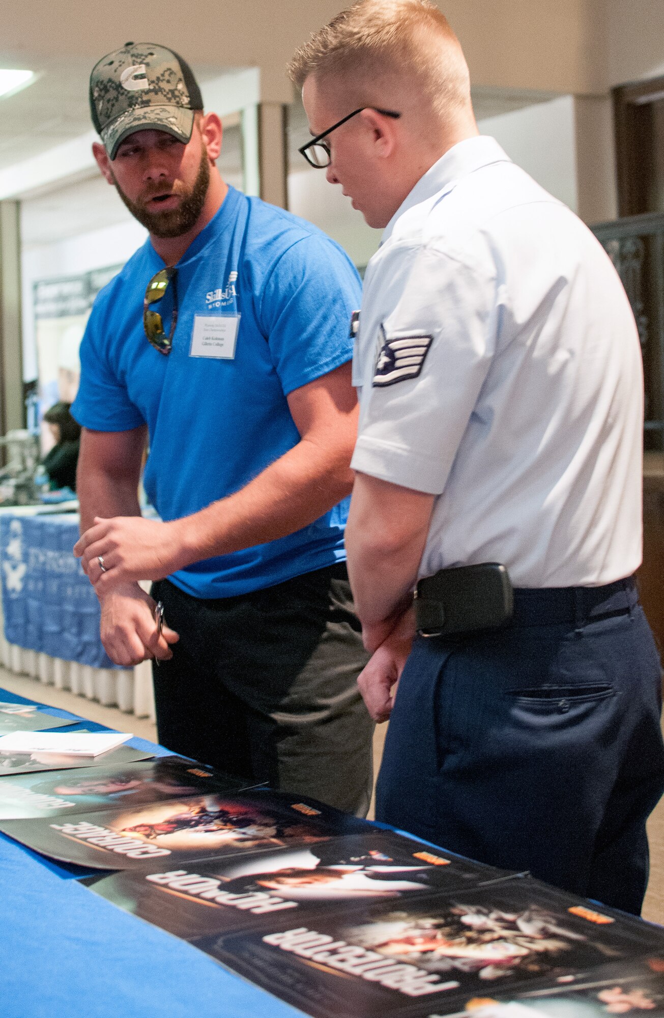 U.S. Air Force Staff Sgt. Michael Palmer, Wyoming Air National Guard recruiter discusses enlistment opportunities with potential enlistees during the SkillsUSA competition, Apr. 13, 2015 in Casper, Wyoming. SkillsUSA Wyoming is a career-technical student organization serving students in secondary and post-secondary technical, skilled, service, and health occupations. (U.S. Air National Guard photo by Tech. Sgt. John Galvin/released)