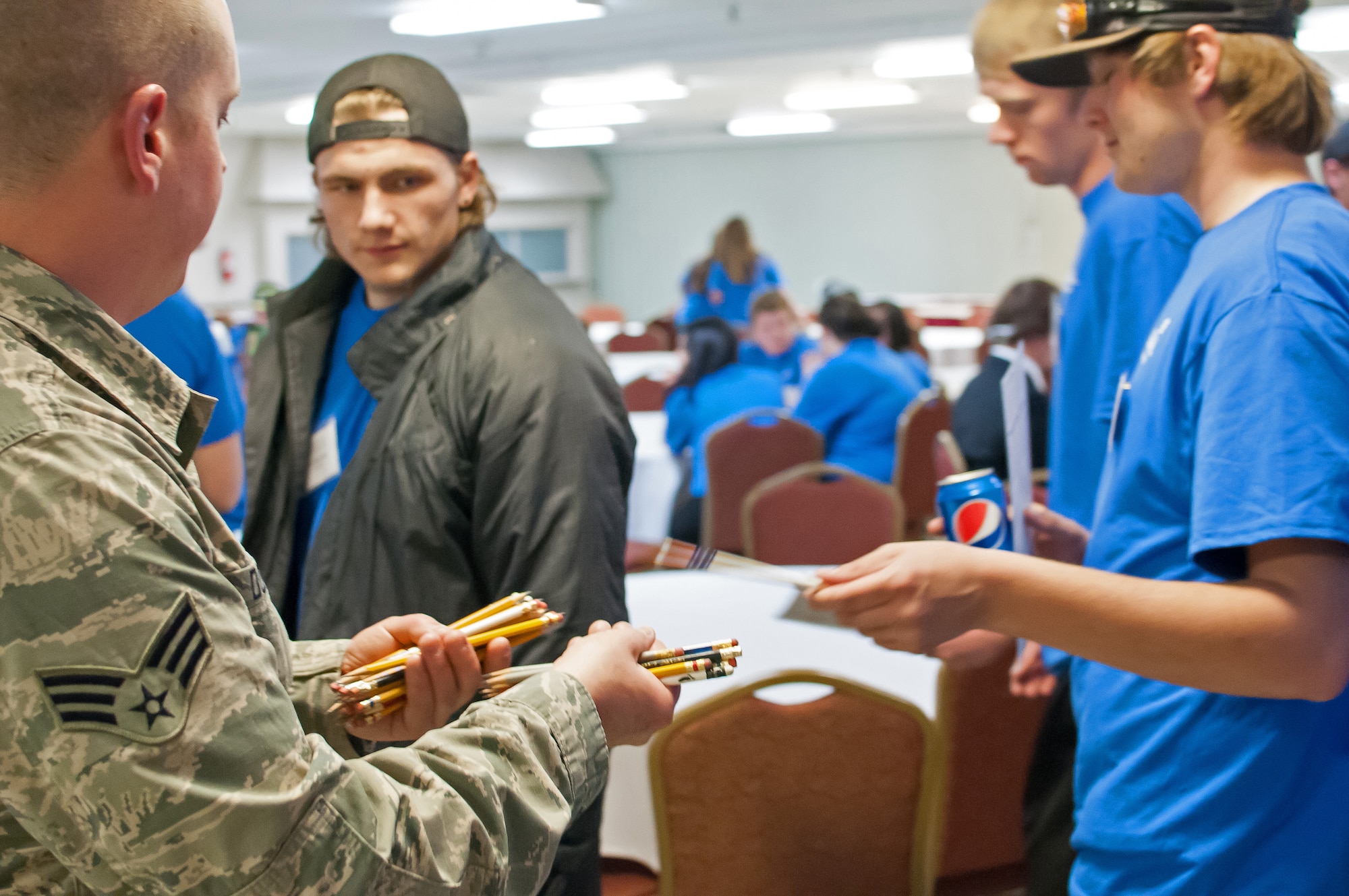 U.S. Air Force Airmen assigned to 153rd Maintenance Group, Wyoming Air National Guard, hand out test materials to students competing in the SkillsUsa competition, Apr. 13, 2015 in Casper, Wyoming. SkillsUSA Wyoming is a career-technical student organization serving students in secondary and post-secondary technical, skilled, service, and health occupations. (U.S. Air National Guard photo by Tech.Sgt John Galvin/released)