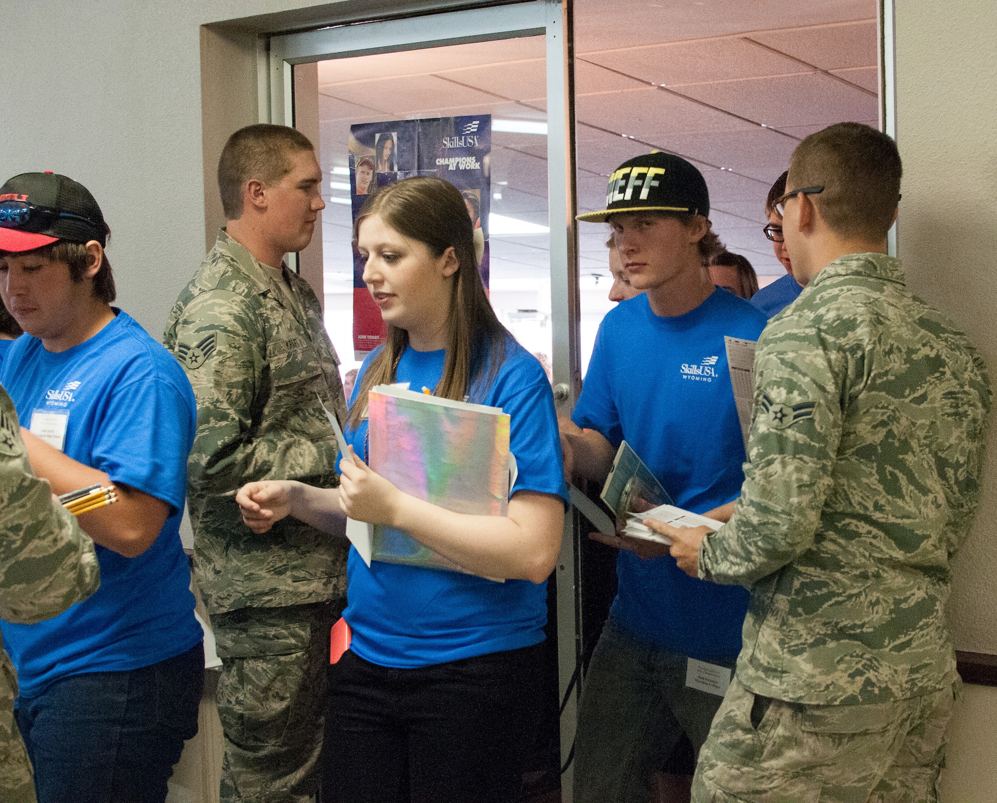 U.S. Air Force Airmen assigned to 153rd Maintenance Group, Wyoming Air National Guard, hand out test materials to students competing in the SkillsUsa competition, Apr. 13, 2015 in Casper, Wyoming. SkillsUSA Wyoming is a career-technical student organization serving students in secondary and post-secondary technical, skilled, service, and health occupations. (U.S. Air National Guard photo by Tech.Sgt John Galvin/released)