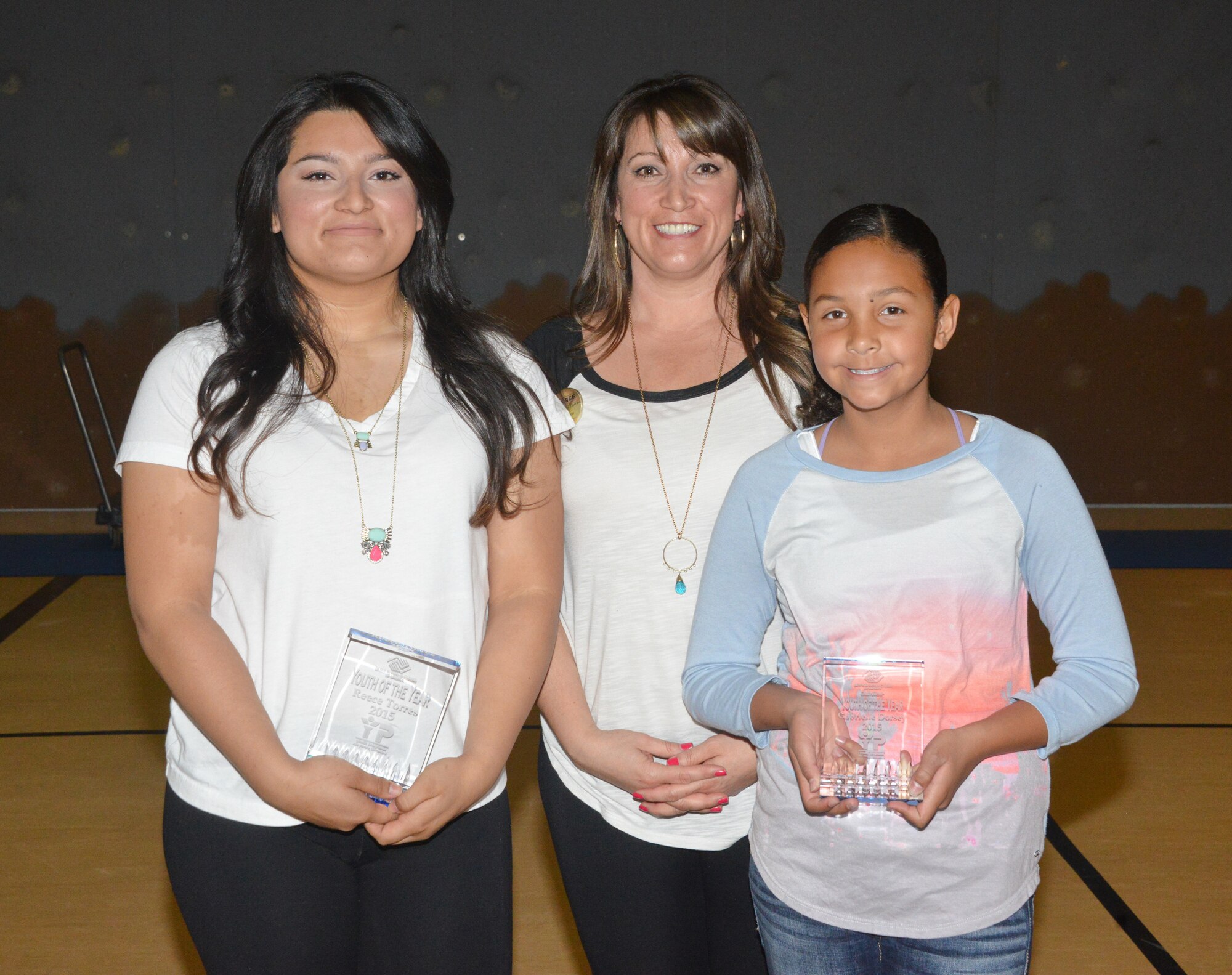 Reece Torres, left, holds her Youth of the Year award with Larri-Lynn Torres, Kirtland’s youth programs director, center, and Gabrielle Dorsey, right, who was named Junior Youth of the Year. (Photo by Dennis Carlson)