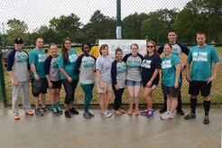 Joint Base Charleston Sexual Assault Prevention and Response team members pose for a portrait at the 2015 Sexual Assault Awareness and Prevention Month kickball tournament held at Locklear Park on Joint Base Charleston Weapons Station, April 11, 2015.  SAPR volunteers serve as victim advocates and also provide training to raise awareness sexual assault. (U.S. Navy photo / Electronics Technician 2nd Class Brittany Pastrick / Released)