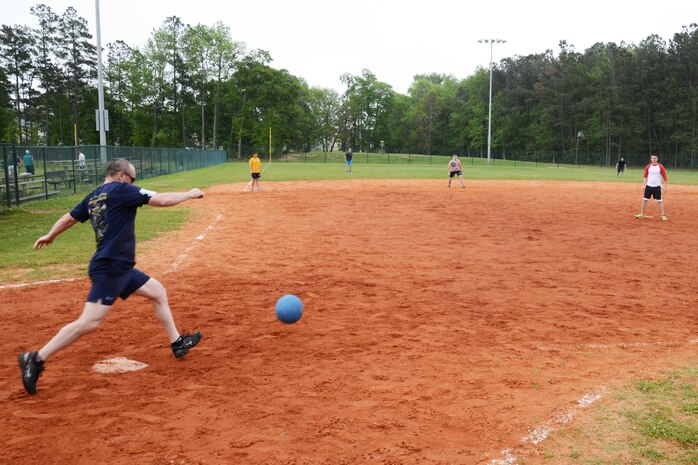 Naval Nuclear Power Training Command Command Master Chief Ronald Nagy kicks a ball to NNPTC students at the 2015 Sexual Assault Awareness and Prevention Month kickball tournament held at Locklear Park on Joint Base Charleston Weapons Station, April 11, 2015.  The event provided a unique opportunity for junior service members to bond with their supervisors while working for a common goal. (U.S. Navy photo / Mass Communication Specialist 2nd Class Jason Pastrick)