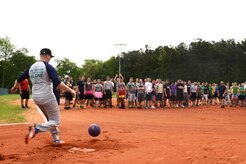 Naval Nuclear Power Training Command staff member Senior Chief Machinist’s Mate Brett Baldwin kicks the ceremonial first pitch thrown by NNPTC Command Master Chief Ronald Nagy at the 2015 Sexual Assault Awareness and Prevention Month kickball tournament April 11, 2015 held at Locklear Park on Joint Base Charleston Weapons Station.  More than 400 service members gathered to discuss and raise awareness of sexual assault. (U.S. Navy photo / Mass Communication Specialist 2nd Class Jason Pastrick)
