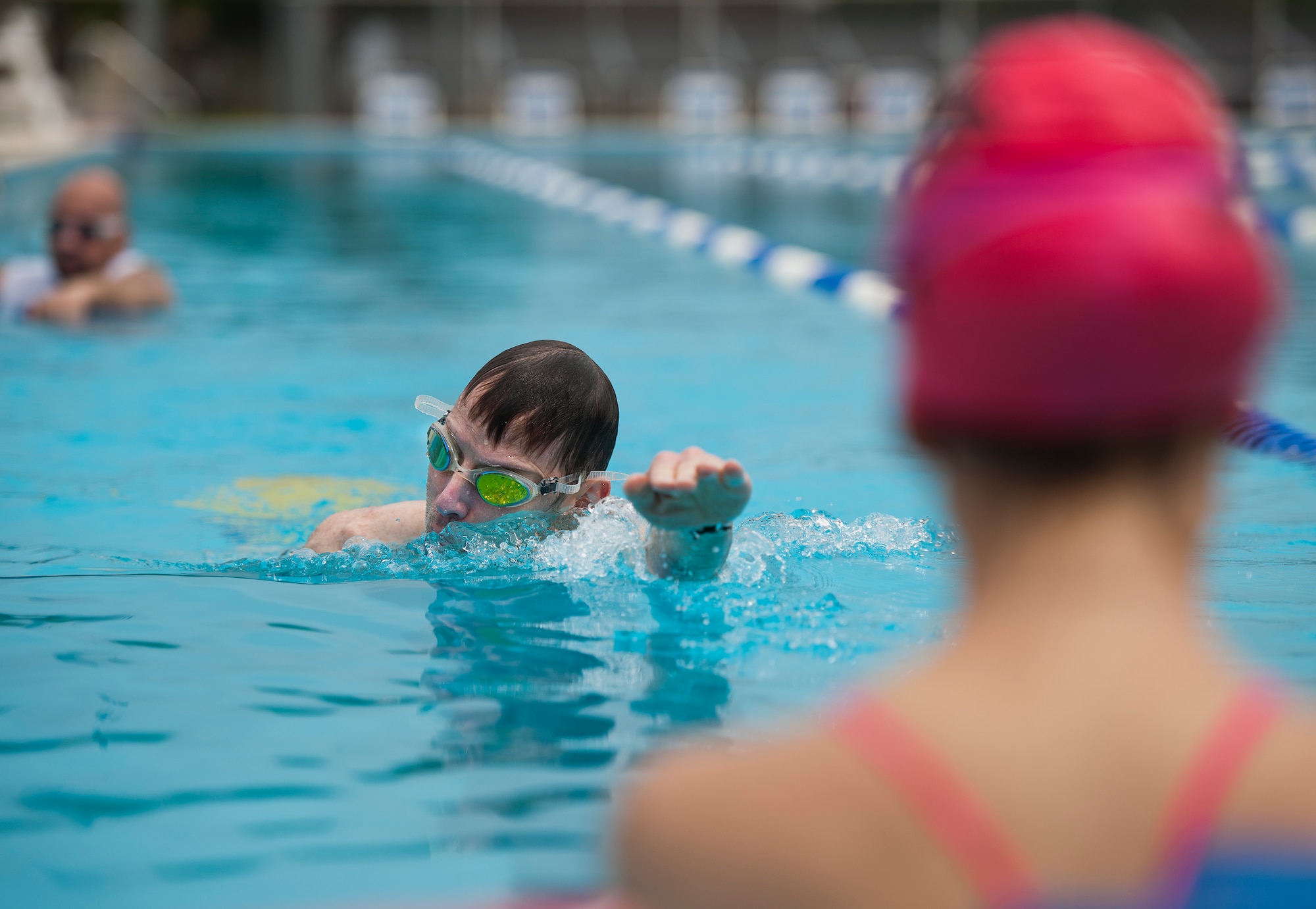 Christopher Valgardson, an Air Force Wounded Warrior athlete, swims toward his coach during the second day of an introductory adaptive sports and rehabilitation camp at Eglin Air Force Base, Fla., April 14. The DOD’s military adaptive sports program enhances warrior recovery by engaging wounded, ill and injured service members in ongoing, daily adaptive activities, based on their interest and ability. (U.S. Air Force photo/Samuel King Jr.)