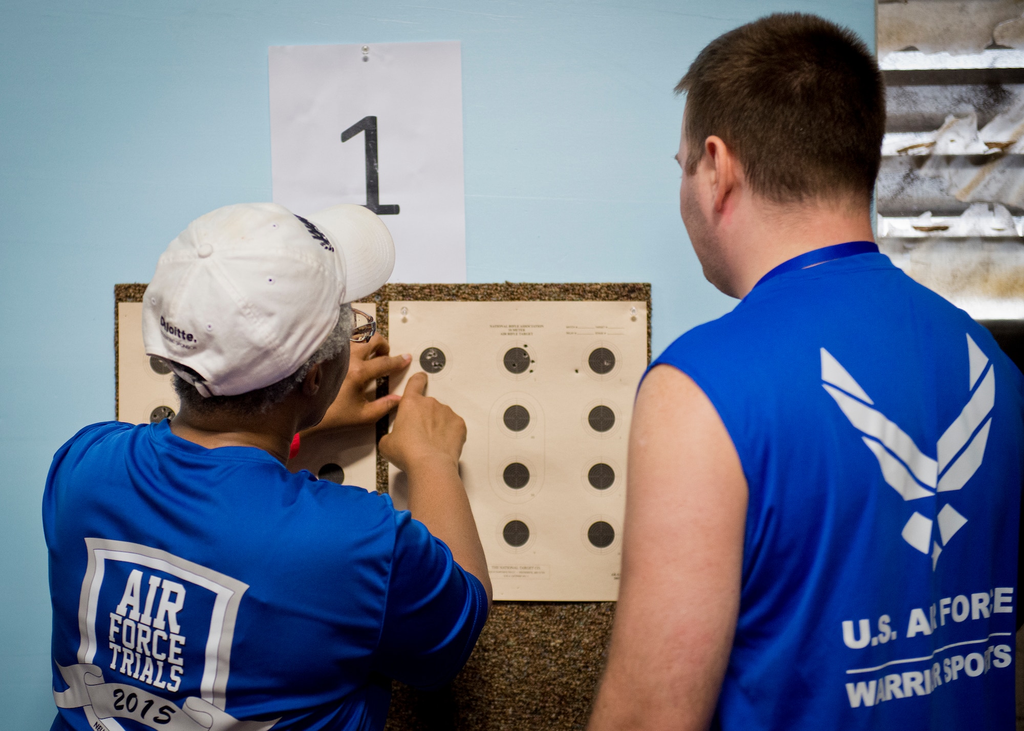 An Air Force Wounded Warrior coach and athlete evaluate a target after a round of shooting during the second day of an introductory adaptive sports and rehabilitation camp at Eglin Air Force Base, Fla., April 14. The DOD’s military adaptive sports program enhances warrior recovery by engaging wounded, ill and injured service members in ongoing, daily adaptive activities, based on their interest and ability. (U.S. Air Force photo/Samuel King Jr.)
