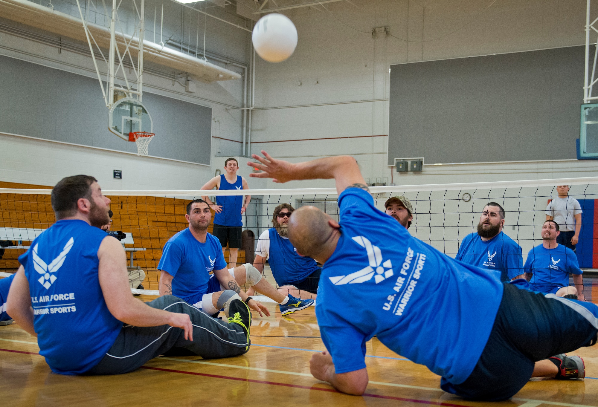 Air Force Wounded Warrior athletes participate in sitting volleyball during the second day of an introductory adaptive sports and rehabilitation camp at Eglin Air Force Base, Fla., April 14. The DOD’s military adaptive sports program enhances warrior recovery by engaging wounded, ill and injured service members in ongoing, daily adaptive activities, based on their interest and ability. (U.S. Air Force photo/Samuel King Jr.)