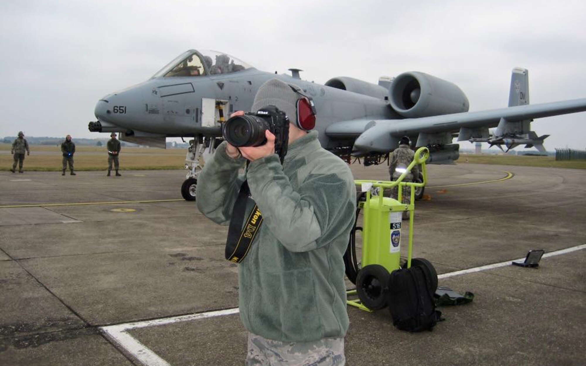 Senior Airman Trevor McBride, 48th Fighter Wing Public Affairs photojournalist, documents the visit of A-10C Thunderbolt II aircraft on the flightline at Royal Air Force Lakenheath, England, March 19, 2015. While visiting RAF Lakenheath for five days, the pilots conducted training alongside NATO allies to demonstrate U.S. commitment to the security and stability of Europe. The imagery McBride provided was published on NATO social media sites. (Courtesy photo/Released) 