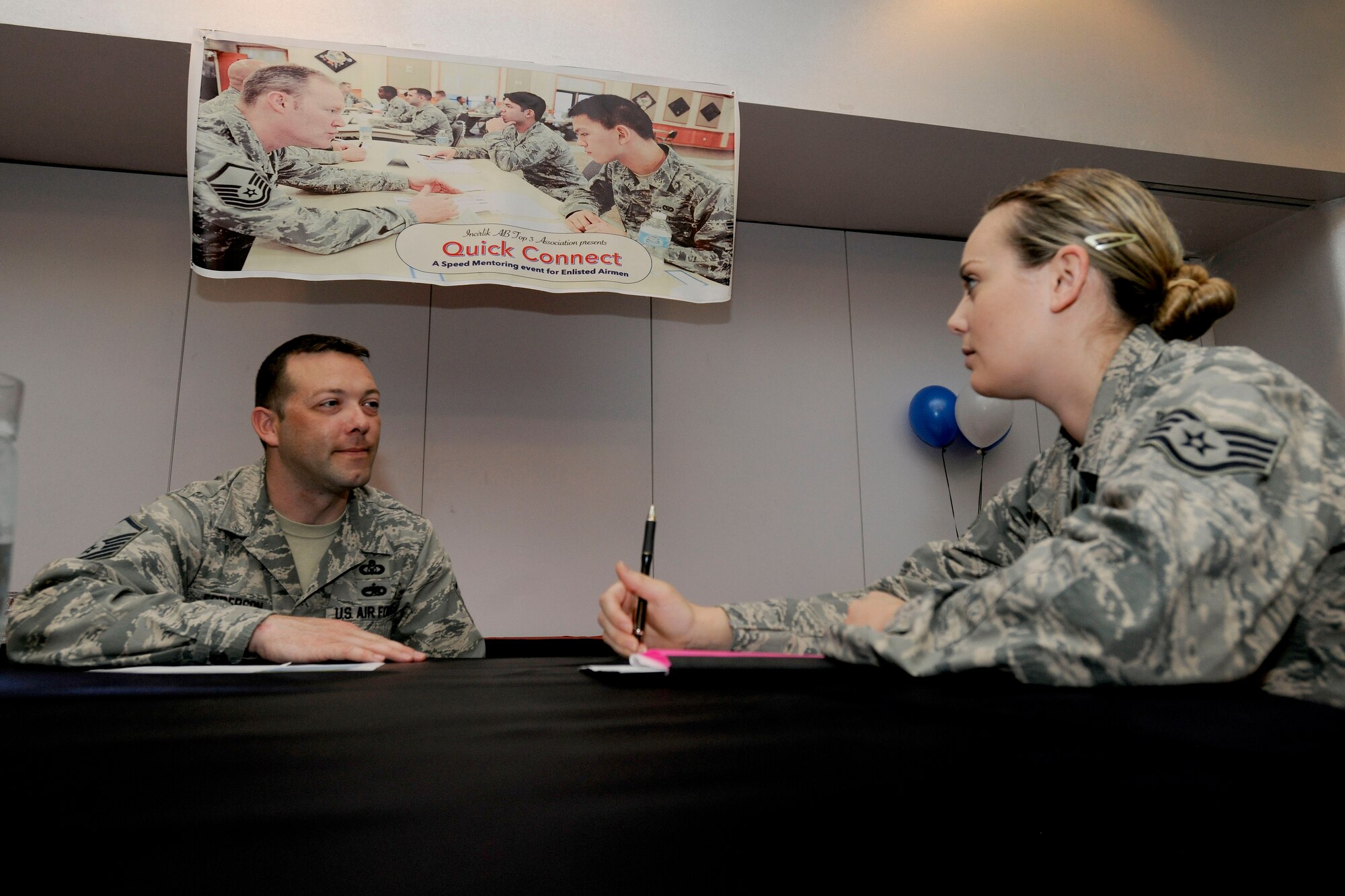 Master Sgt. Eric Epperson, 39th Operations Support Squadron NCO in charge of standardization and evaluation, speaks with Staff Sgt. Andrea Stalter, 39th OSS airfield management operations supervisor, during a speed mentoring event April 13, 2015, at Incirlik Air Base, Turkey. The session provided a simple way for Airmen to meet potential mentors with the goal of creating long term career mentorship. (U.S. Air Force photo by Senior Airman Krystal Ardrey/Released)