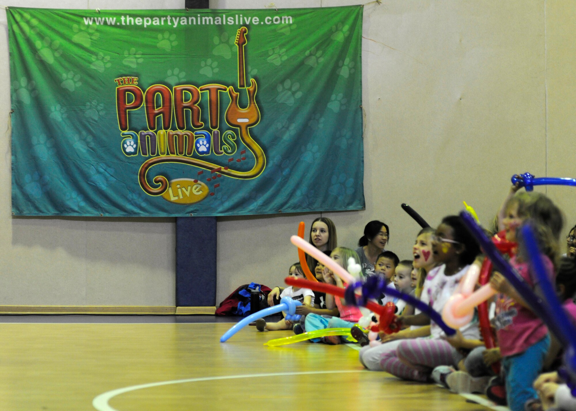 Children wait for a concert by the Party Animals to begin April 10, 2015, at Incirlik Air Base, Turkey. Beginning their base tours in 2007, the Party Animals are on their sixth tour with Armed Forces Entertainment. (U.S. Air Force photo by Senior Airman Krystal Ardrey/Released)