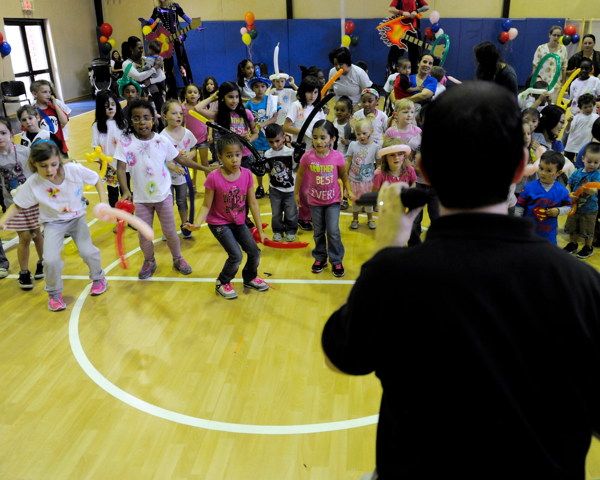 Mark Ruegg, Party Animals director and host, encourages children to dance before a Party Animals concert April 10, 2015, at Incirlik Air Base, Turkey.  The event also included face painting, balloon animals, stilt walkers and a bouncy castle. (U.S. Air Force photo by Senior Airman Krystal Ardrey/Released)