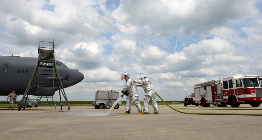 Senior Airmen Nathan Weber, left, 2nd Civil Engineer Squadron, and Jeremy Gobert, right, 307th CES, firefighters, run a fire hose as part of their training on the flightline of Barksdale Air Force Base, La., April 8, 2015. Firefighters use exercises to hone their skills while using the opportunity to optimize response procedures. Weber says that being a firefighter means being willing to sacrifice your life for the lives of others, and when they rush into a fire, they know they might not be coming home, but the people they’re pulling from the flames will be. (U.S. Air Force photo/Airman 1st Class Curt Beach)