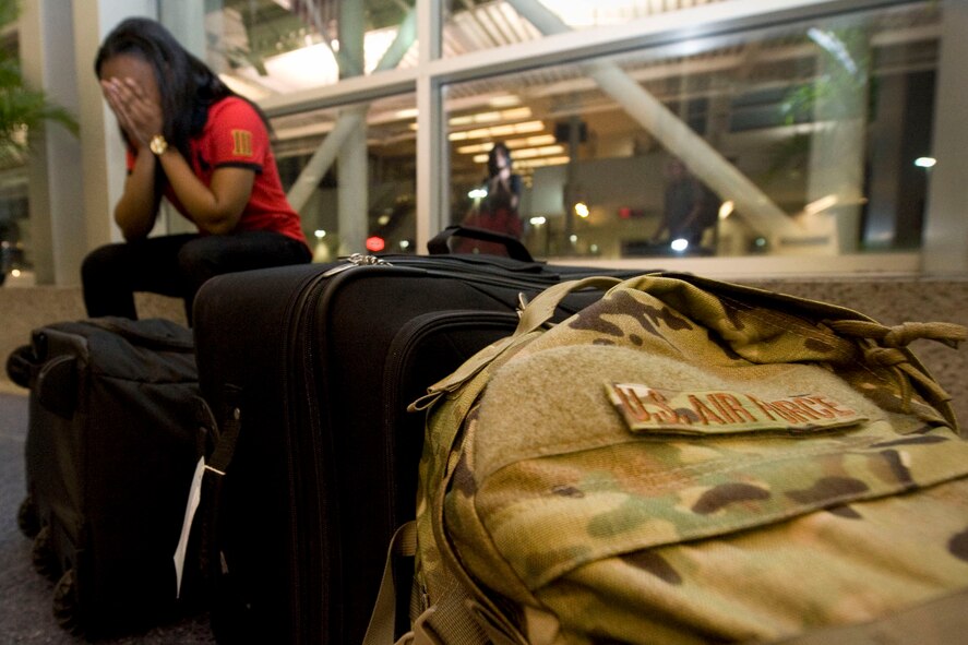 Senior Airman Ashley Thompson, 2nd Communications Squadron network operations technician waits to check-in her luggage at the Shreveport Regional Airport, Shreveport, La., April 8, 2015. Thompson deployed to Bagram Airfield,  Afghanistan, in support of Operation Freedom Sentinel.  Thompson believes ?Service? is an act of selflessness for the greater good of the country. (U.S. Air Force photo/ Senior Airman Jannelle Dickey)