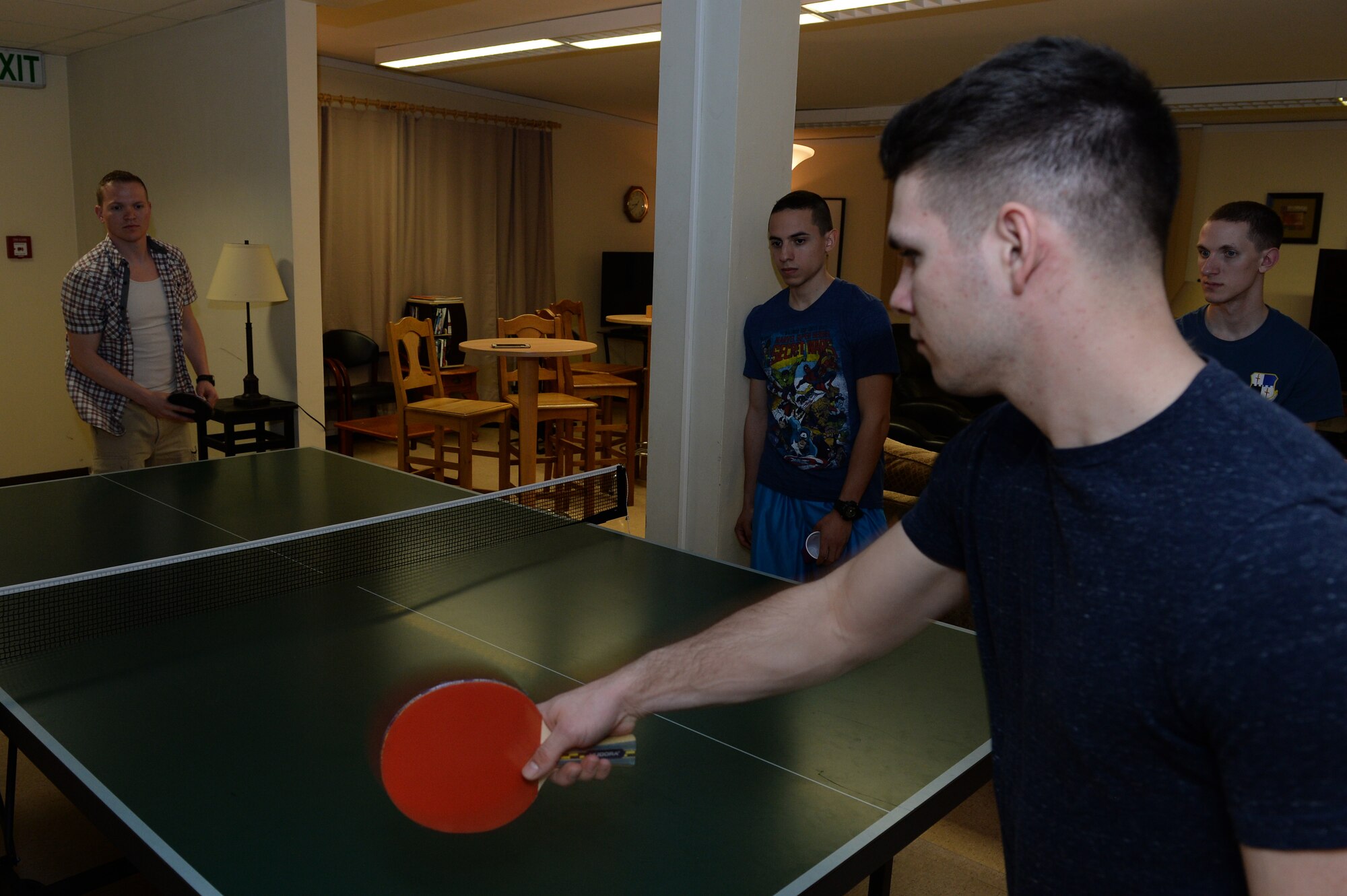 Two U.S. Air Force Airman play pingpong as others look on April 10, 2015, at the Coffee Mill on Spangdahlem Air Base, Germany. The chapel recently decided to expand the hours of operations to Tuesday-Wednesday from 6-10 p.m., Thursday from 7:30-10 p.m. and Friday-Saturday from 7-11 p.m. (U.S. Air Force photo by Senior Airman Dylan Nuckolls/Released)