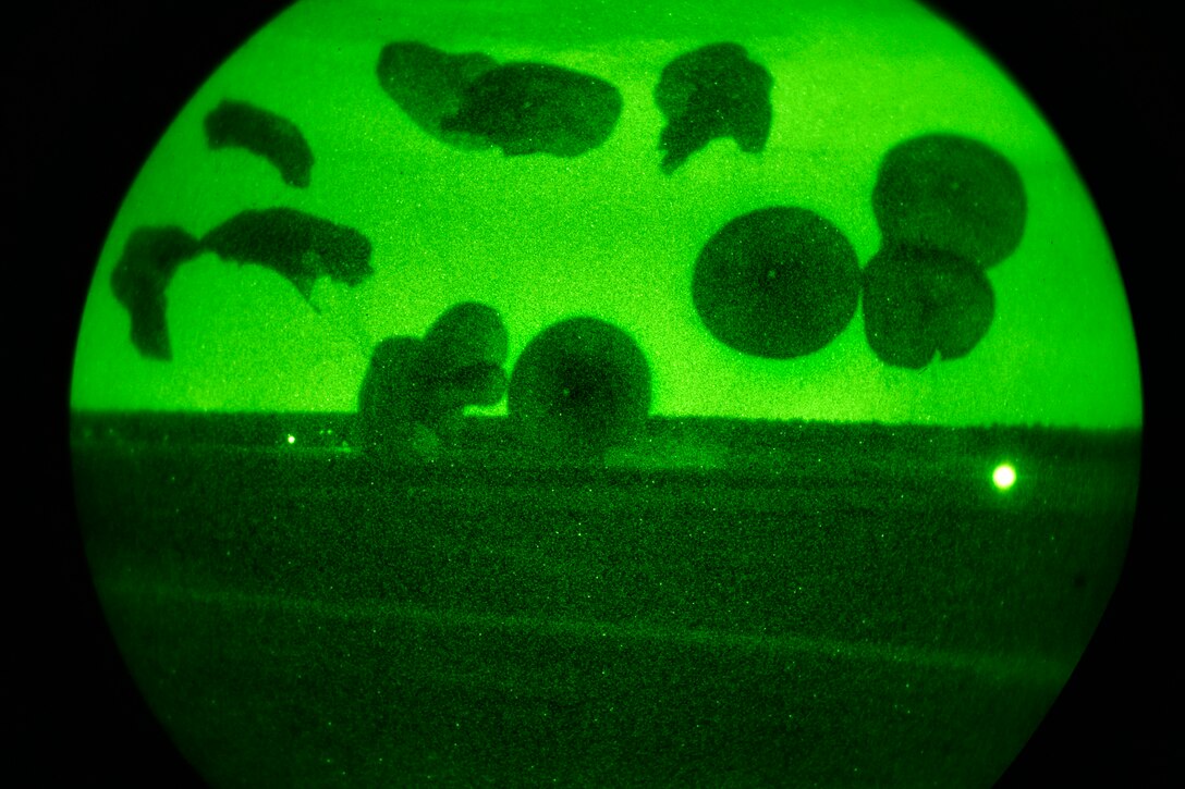 As seen through a night-vision device, U.S. and British paratroopers perform a static line jump during Combined Joint Operational Access Exercise 15-01 on Fort Bragg, N.C., April 13, 2015. The U.S. paratroopers are assigned to the 82nd Airborne Division and the British paratroopers are assigned to the 3rd Battalion, Parachute Regiment, 16 Air Assault Brigade. 