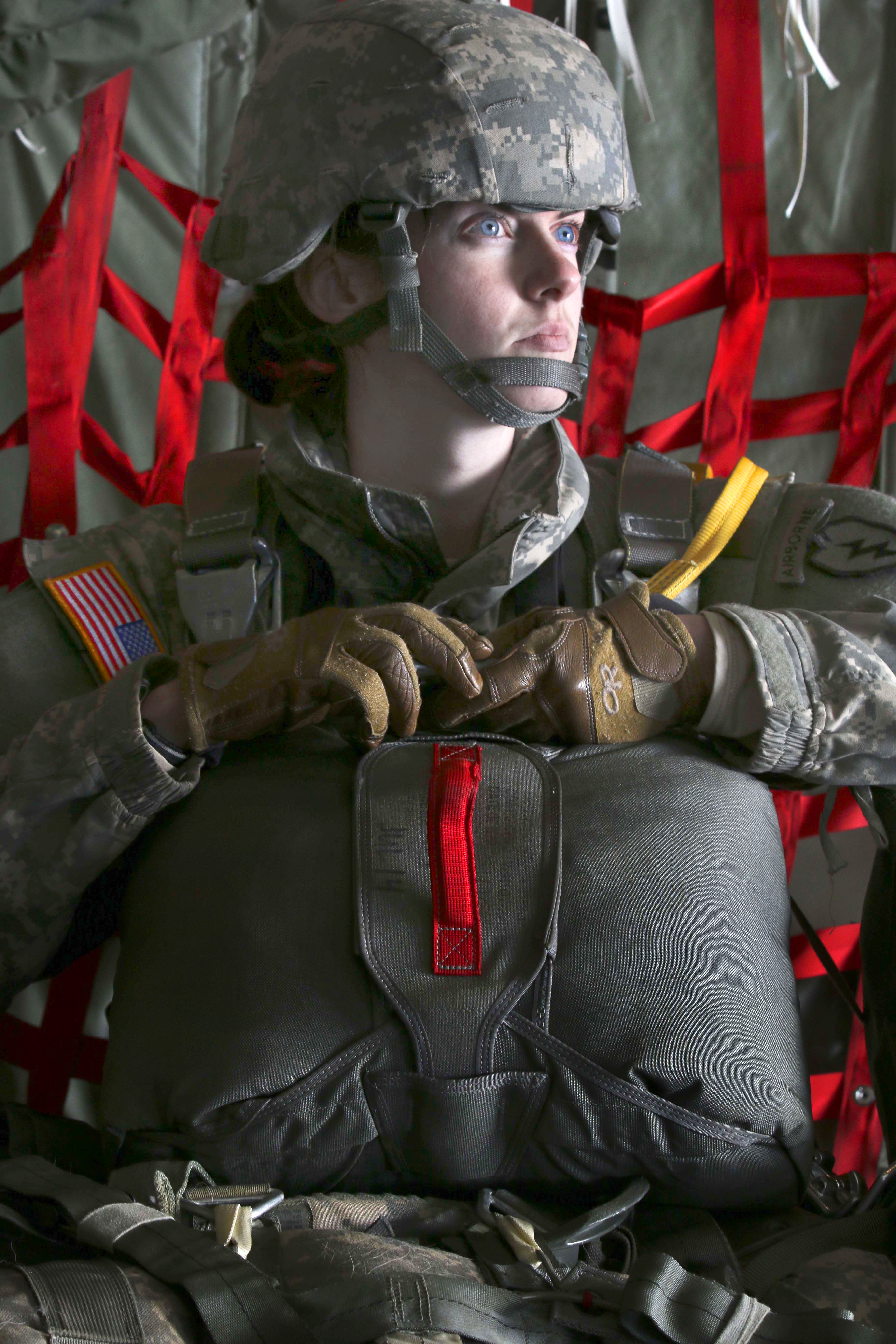 Army 1st Lt. Lauren Hogg waits to hook up her static line to the