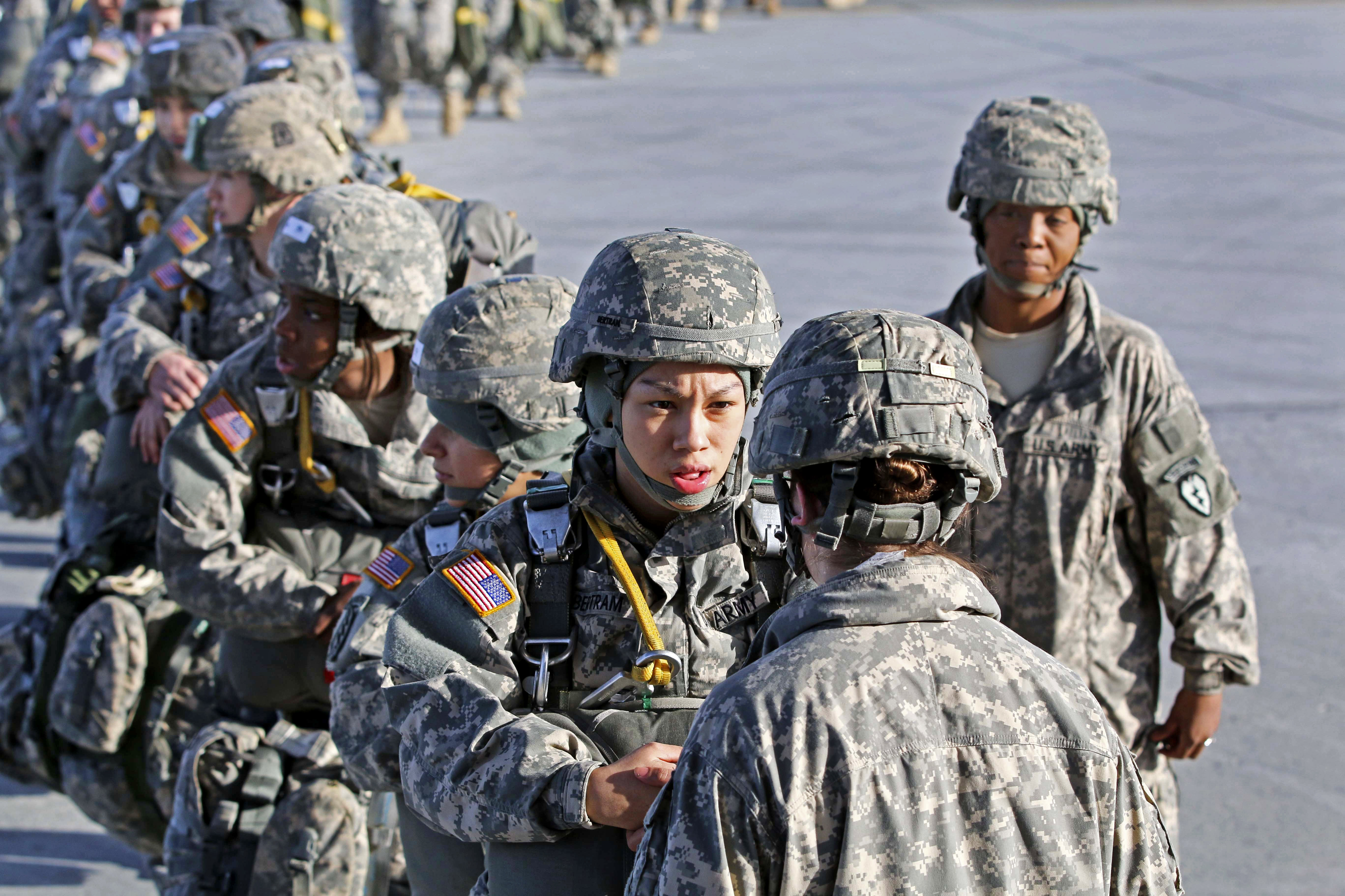 Paratroopers wait to board a U.S. Marine Corps C130 Hercules at the