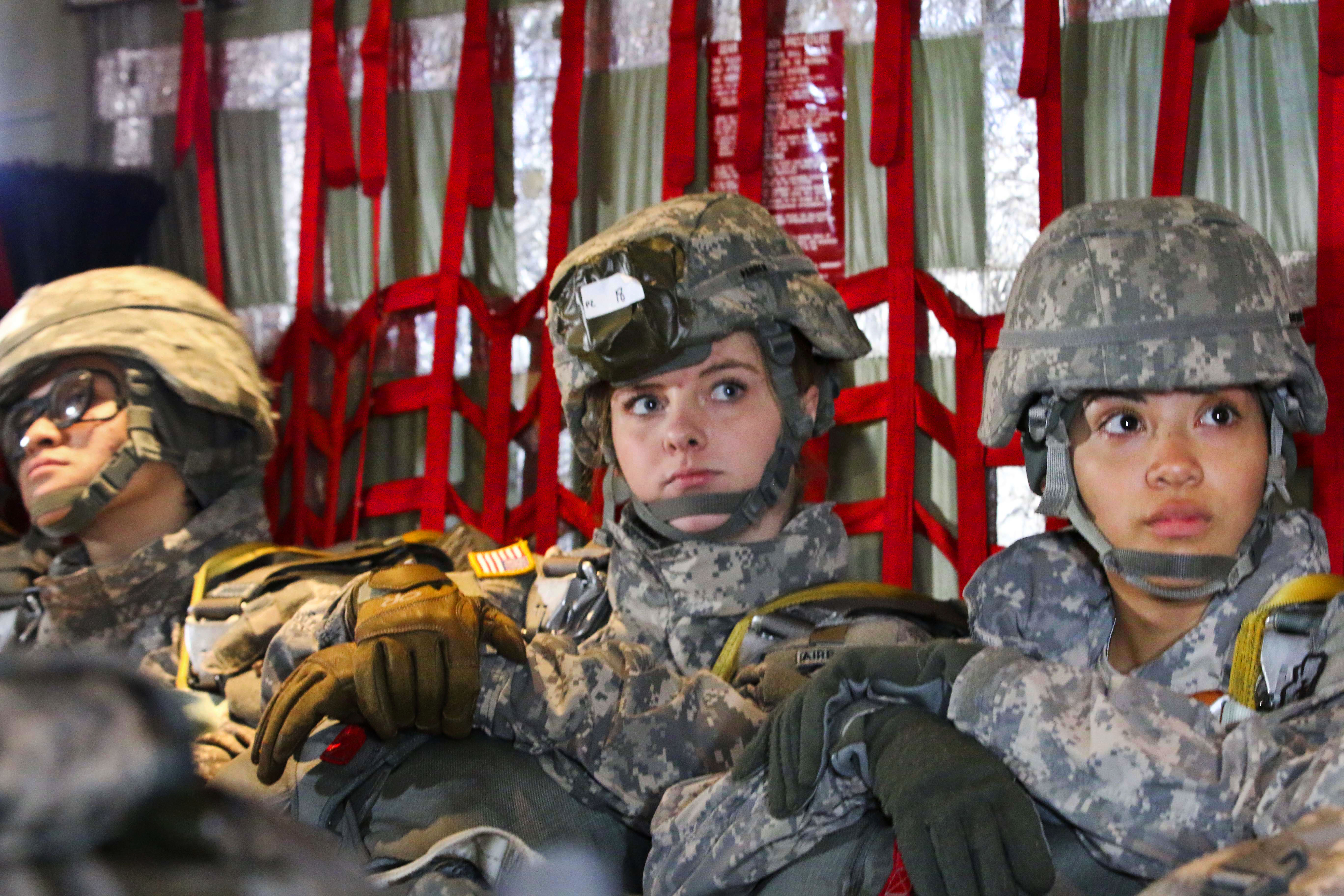 Paratroopers await the command to hook up their static lines to the