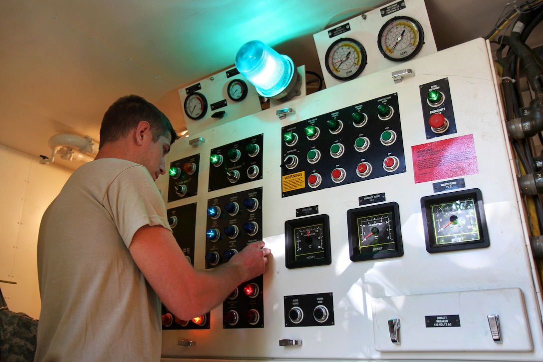 U.S. Army Spc. Todd S. Boban operates a reverse osmosis water