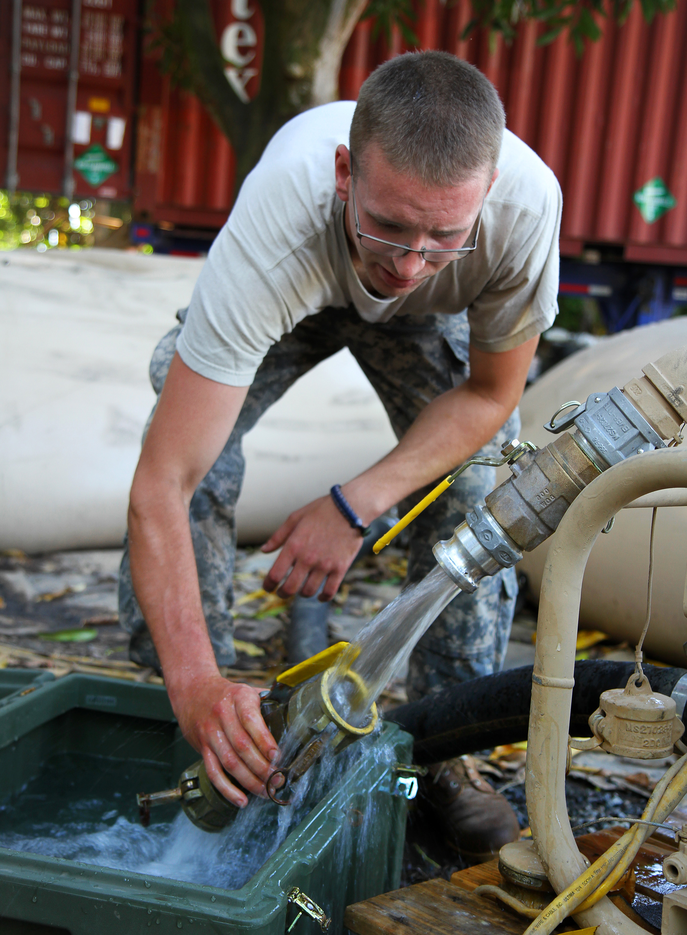U S Army Sgt Robert M Giran Rinses Off A Water Purification Unit Component During Beyond The