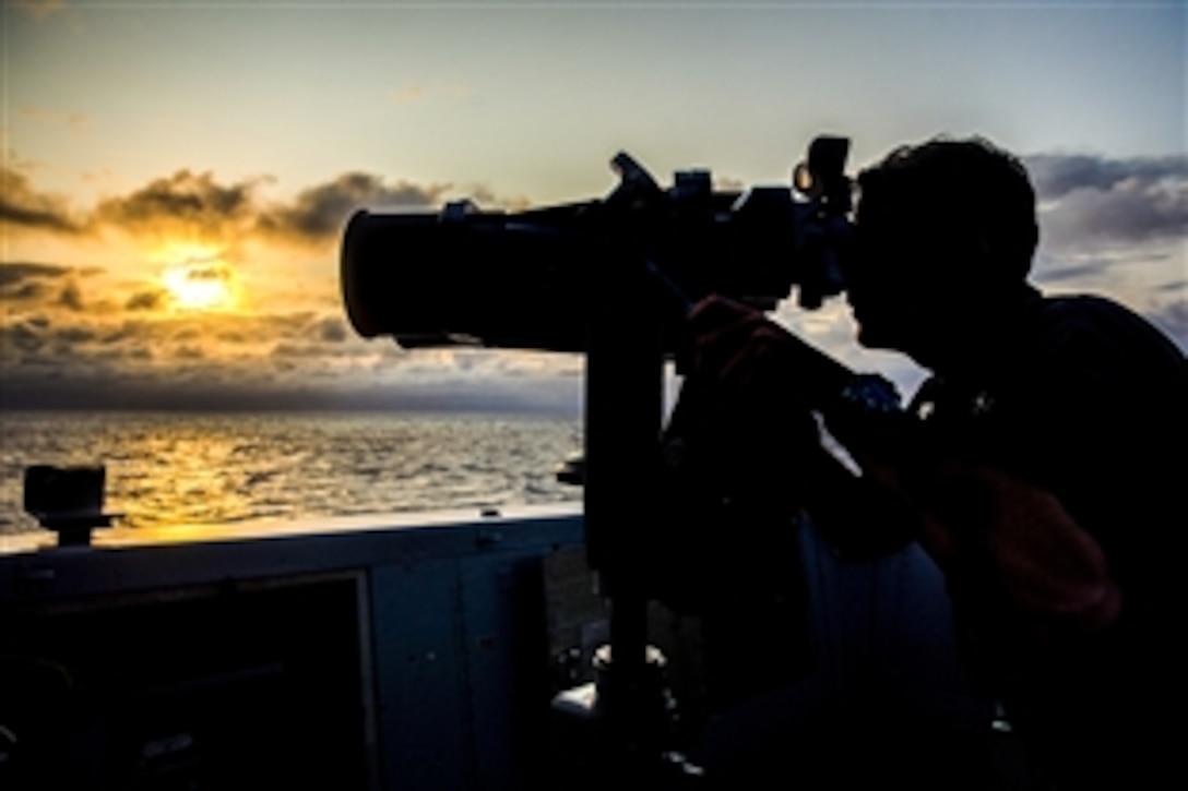 U.S. Navy Petty Officer 2nd Class Vincent Neighbor monitors nearby surface contacts from the bridge  of the amphibious transport dock ship USS Green Bay in the U.S. 7th Fleet area of responsibility in the East China Sea, April 11, 2015.