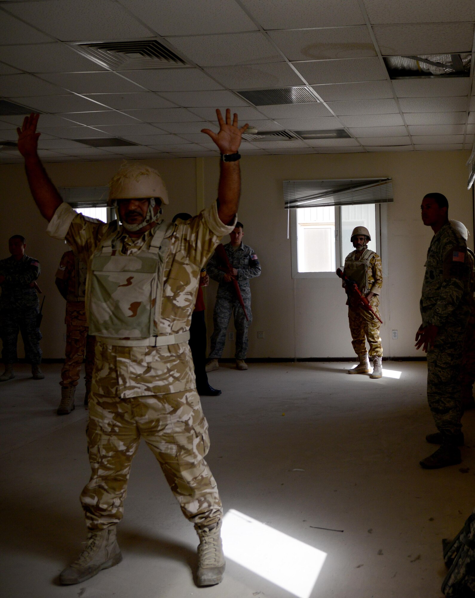 Members of the Qatar Emiri Air Force practice personnel challenging procedures during joint interoperability training April 14, 2015, at Al Udeid Air Base, Qatar. Airmen from the 379th Expeditionary Security Forces Squadron shared techniques and procedures with members of the QEAF during this joint training. Training like this enhances the interoperability of both the U.S. and its host nation partners and helps improve bilateral relations by sharing techniques on how each country operates. (U.S. Air Force photo by Senior Airman Kia Atkins)