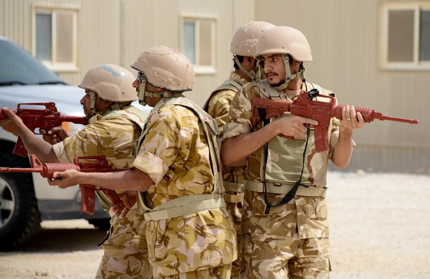 Members of the Qatar Emiri Air Force practice a diamond fire team movement during joint interoperability training April 14, 2015, at Al Udeid Air Base, Qatar. This type of movement can be used during patrols or moving through buildings. Airmen from the 379th Expeditionary Security Forces Squadron shared techniques and procedures with members of the Qatar Emiri Air Force during this joint training. Training enhances the interoperability of both the U.S. and its host nation partners and helps improve bilateral relations by sharing techniques on how each country operates. (U.S. Air Force photo/Senior Airman Kia Atkins) 
