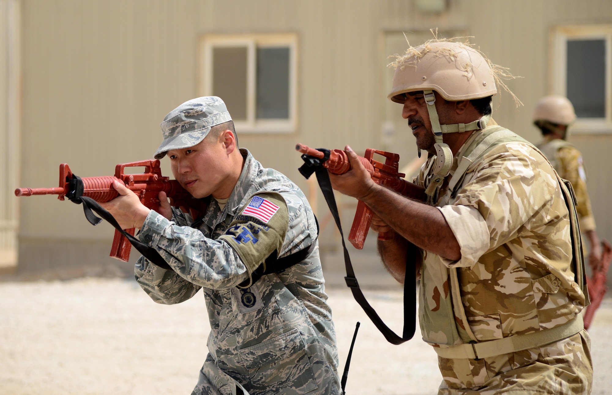 U.S. Air Force Staff Sgt. Jason Ventura, 379th Expeditionary Security Forces Squadron Check Six facilitator, demonstrates proper weapon holding procedures during joint interoperability training April 14, 2015, at Al Udeid Air Base, Qatar. Airmen from the 379th ESFS shared techniques and procedures with members of the Qatar Emiri Air Force during this joint training. Training like this enhances the interoperability of both the U.S. and its host nation partners and helps improve bilateral relations by sharing techniques on how each country operates. (U.S. Air Force photo by Senior Airman Kia Atkins)