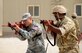 U.S. Air Force Staff Sgt. Jason Ventura, 379th Expeditionary Security Forces Squadron, demonstrates proper weapon holding procedures during joint interoperability training April 14, 2015, at Al Udeid Air Base, Qatar. Airmen from the 379th ESFS shared techniques and procedures with members of the Qatar Emiri Air Force during the joint training. Training enhances the interoperability of both the U.S. and its host nation partners and helps improve bilateral relations by sharing techniques on how each country operates. (U.S. Air Force photo/Senior Airman Kia Atkins)