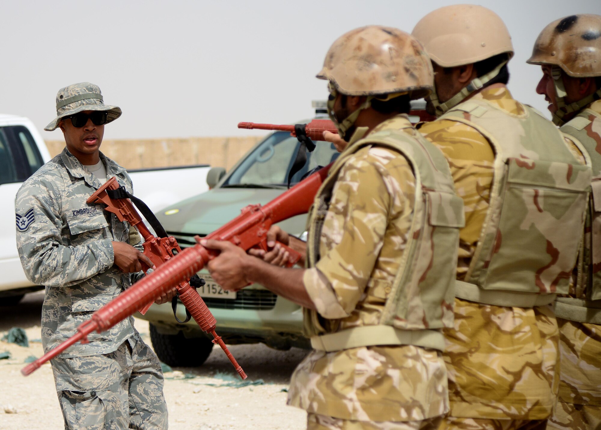 U.S. Air Force Staff Sgt. Jared Kimbrough, 379th Expeditionary Security Forces Squadron Check Six facilitator, explains fire team movement formations to members of the Qatar Emiri Air Force during joint interoperability training April 14, 2015, at Al Udeid Air Base, Qatar. Airmen from the 379th ESFS shared techniques and procedures with members of the QEAF during this joint training. Training like this enhances the interoperability of both the U.S. and its host nation partners and helps improve bilateral relations by sharing techniques on how each country operates. (U.S. Air Force photo by Senior Airman Kia Atkins)
