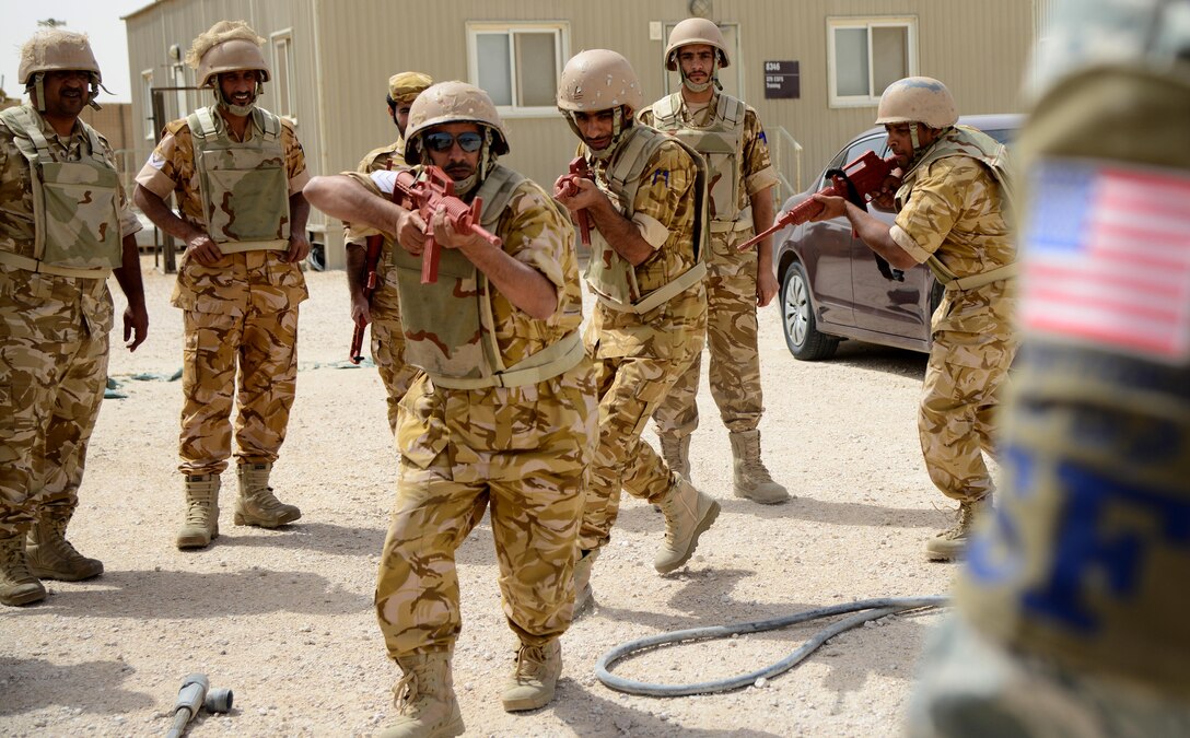 Members of the Qatar Emiri Air Force practice building clearing procedures during joint interoperability training April 14, 2015, at Al Udeid Air Base, Qatar. Airmen from the 379th Expeditionary Security Forces Squadron shared techniques and procedures with members of the QEAF during this joint training. Training like this enhances the interoperability of both the U.S. and its host nation partners and helps improve bilateral relations by sharing techniques on how each country operates. (U.S. Air Force photo by Senior Airman Kia Atkins)