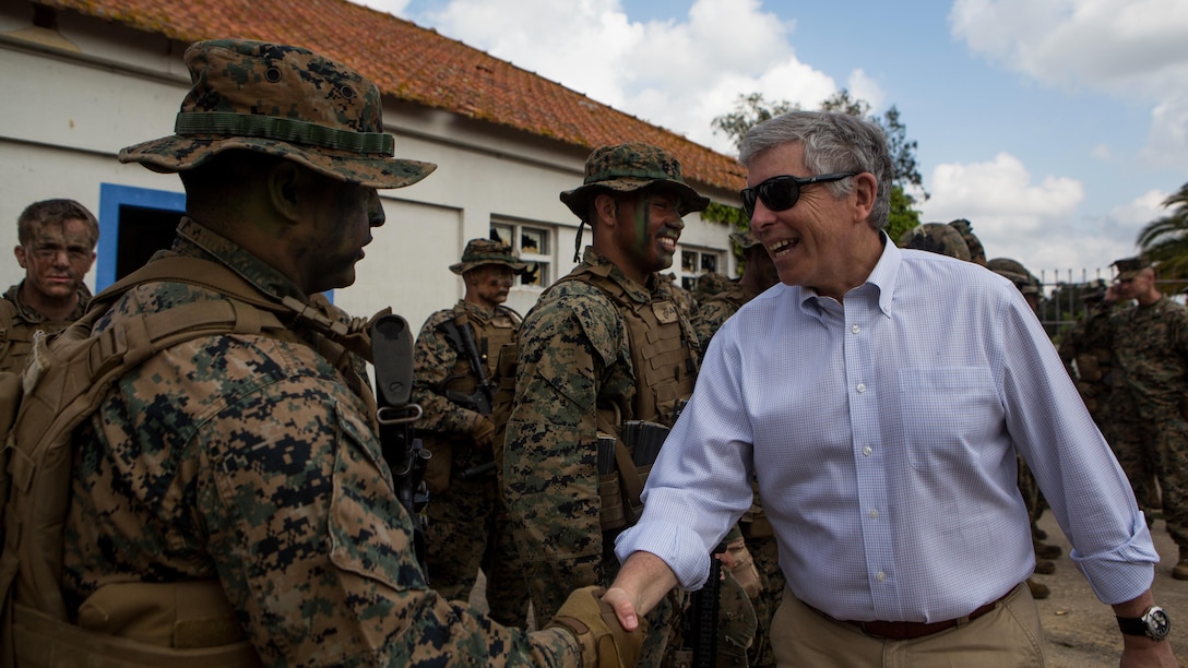 U.S.  Portugal Ambassador Robert A. Sherman, right, shakes hands with U.S. Marine Corps Cpl. Tomas Herrera, a team leader with Special-Purpose Marine Air-Ground Task Force Crisis Response-Africa, after an assault training exercise near Lisbon, Portugal, April 10, 2015. Marines stationed out of Moron Air Base, Spain, traveled to Portugal to utilize a variety of different ranges and training exercises alongside with the Portuguese Marines. After a week of training together, Marines and Fuzileiros were more familiarized with each other’s tactics and operating procedures in case of future joint operations. 