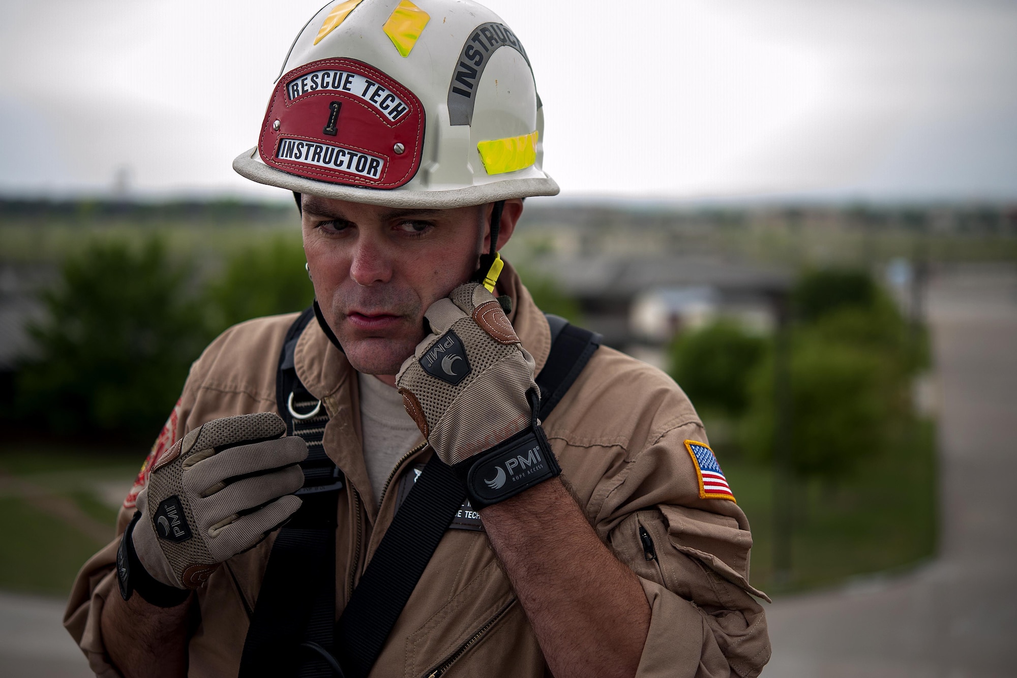 Tech. Sgt. Aaron C. Brackett, the 312th Training Squadron rescue course NCO in charge, adjusts his hard hat’s chin strap before rappelling at the Louis F. Garland Department of Defense Fire Academy April 8, 2015. Brackett and his students assess safety precautions before conducting any training at the fire academy. (U.S. Air force photo/Airman 1st Class Devin Boyer)